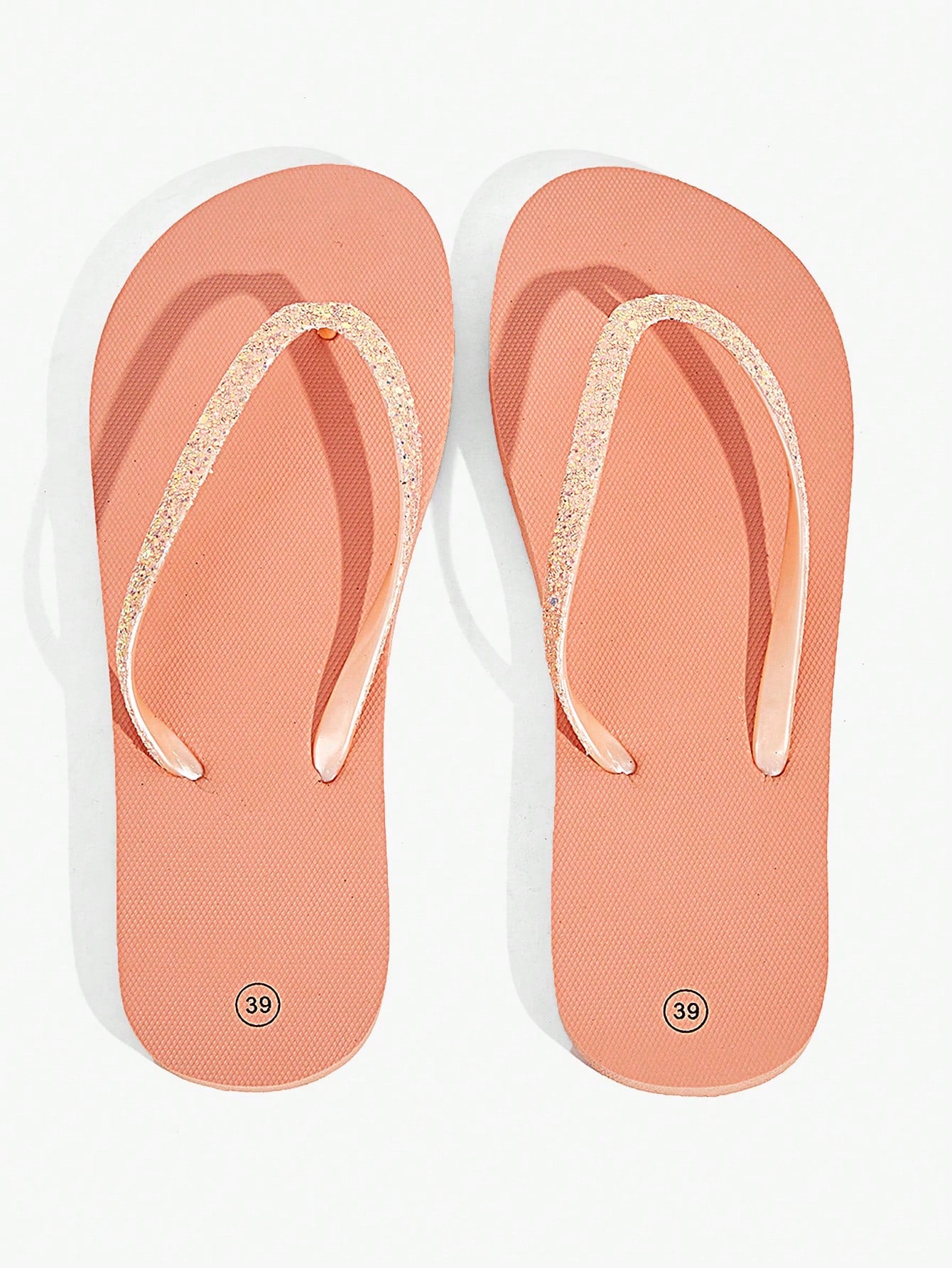 Pair of women’s apricot flat flip-flops with a glitter upper and plain design, suitable for beach, outdoor, home, and vacation wear.
