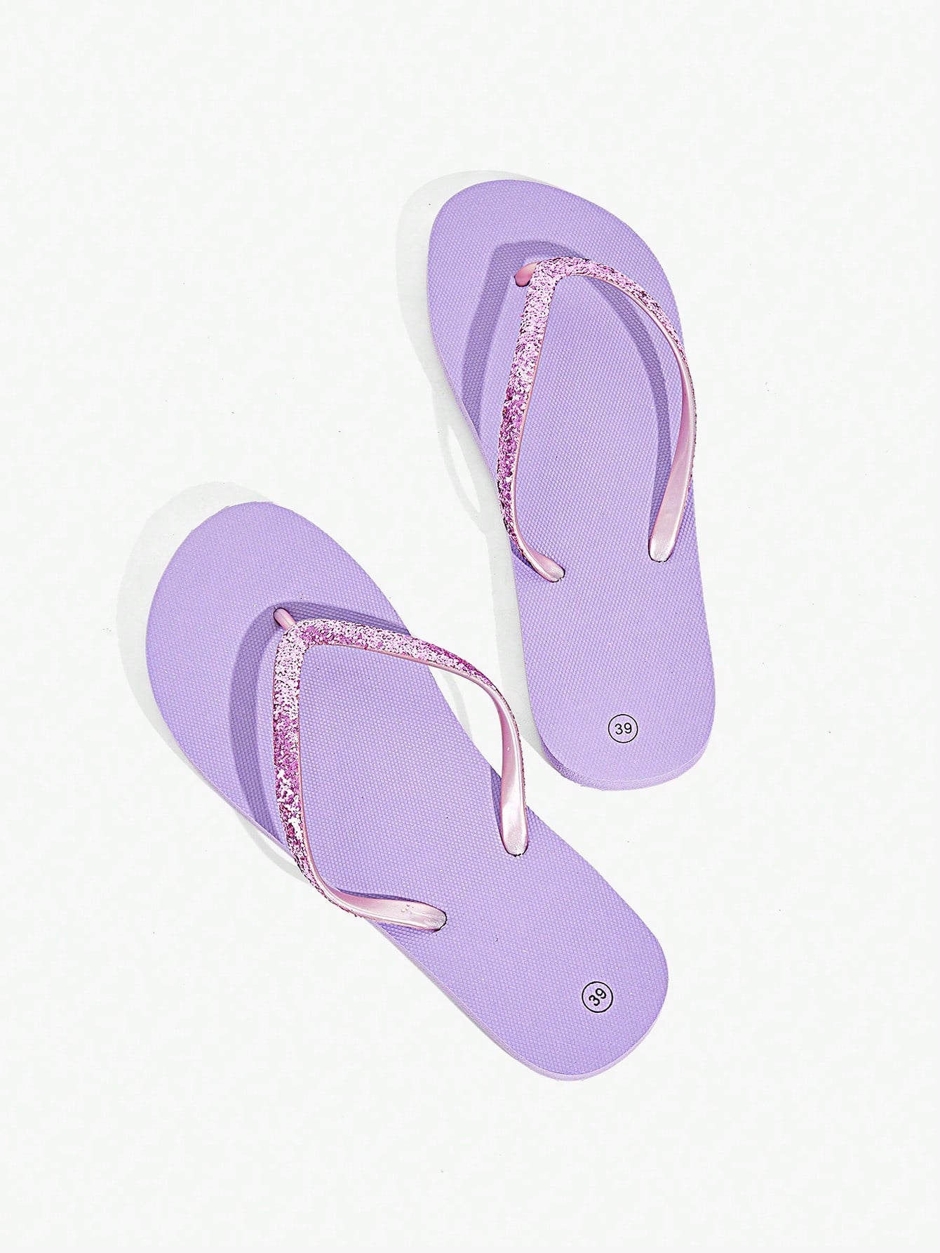 Pair of women’s apricot flat flip-flops with a glitter upper and plain design, suitable for beach, outdoor, home, and vacation wear.