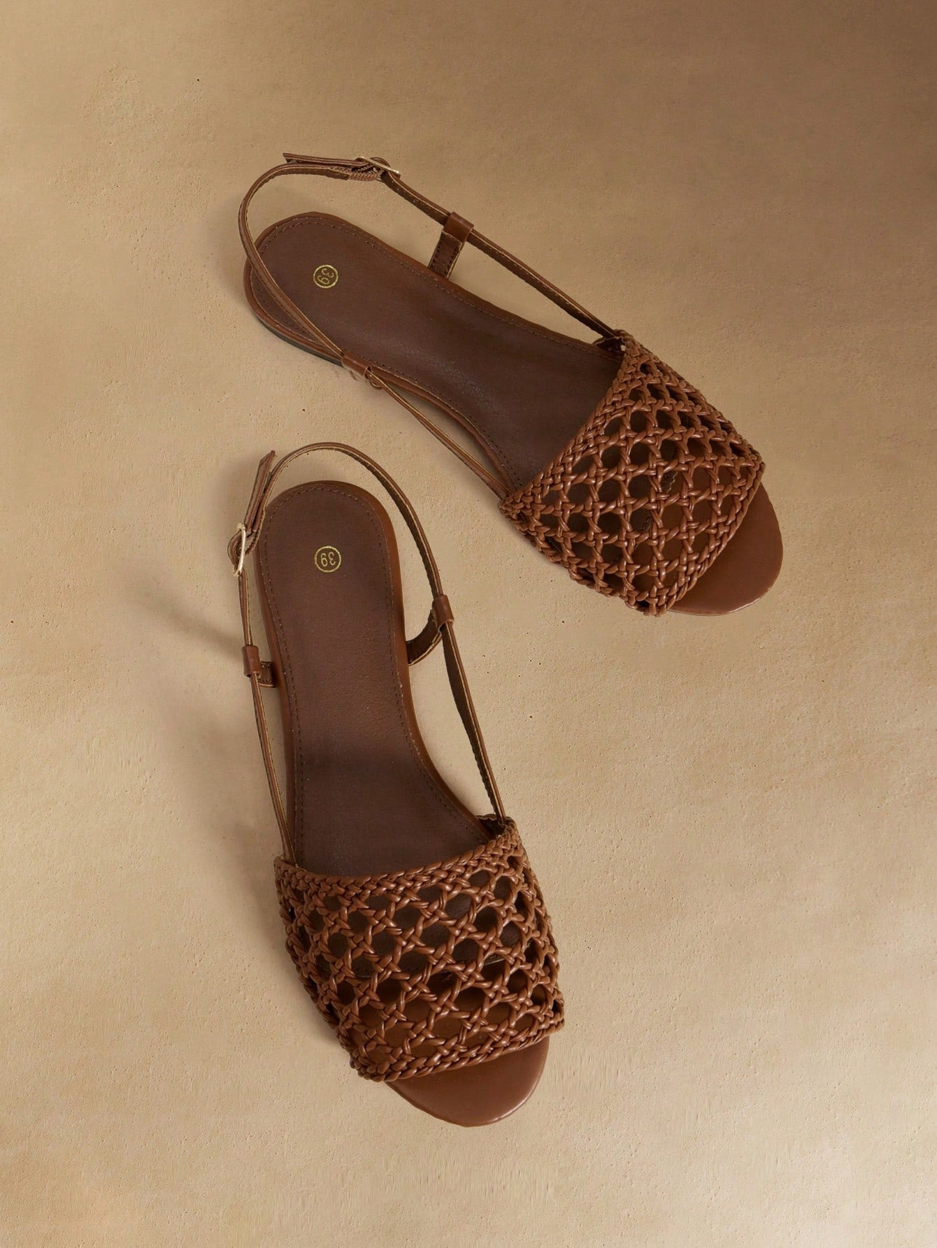 Women's flat gladiator sandals featuring a hollow-out multi-strap woven design and ankle strap style, with striped pattern and casual beach vacation look.