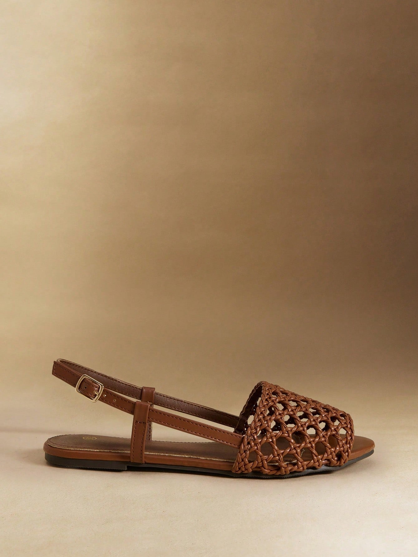 Women's flat gladiator sandals featuring a hollow-out multi-strap woven design and ankle strap style, with striped pattern and casual beach vacation look.