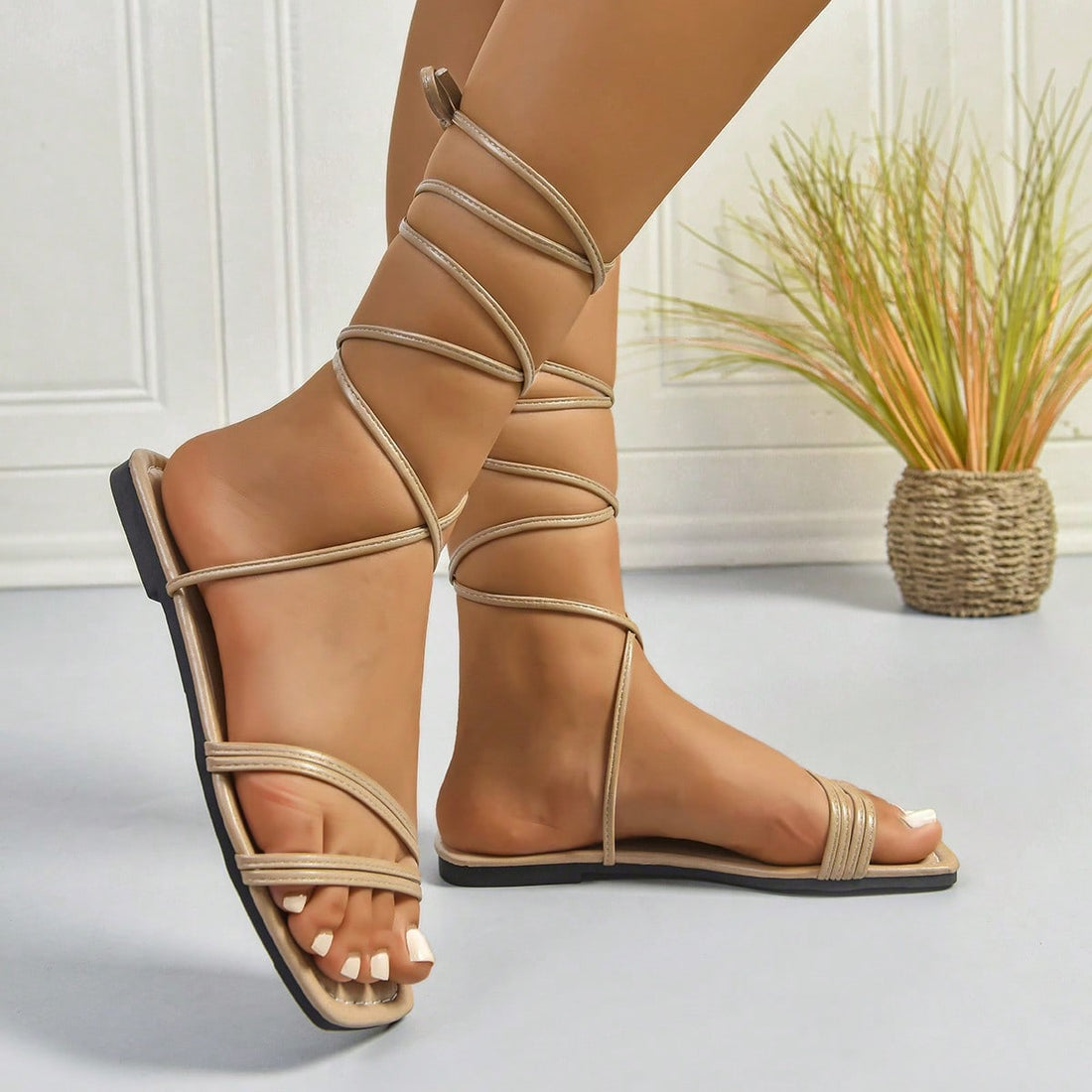 Women's khaki tie-up woven flat sandals with a square open toe and buckle detail, beach-style slide design.