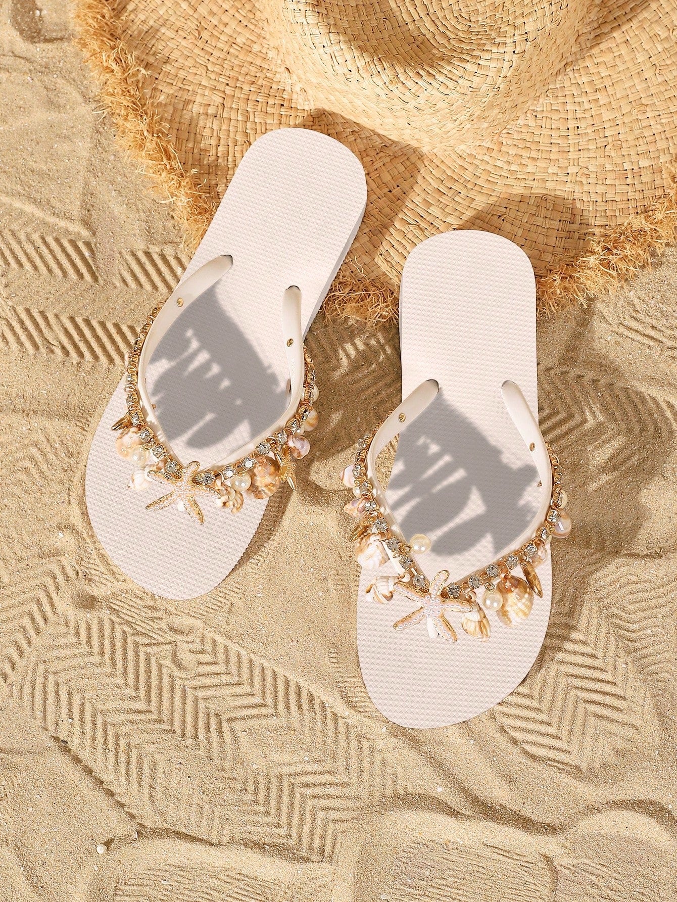 Women’s fashion flip flops with thong strap, beaded shell chain decoration, and removable decor chain detail, designed with a soft flat sole for beach and vacation use.