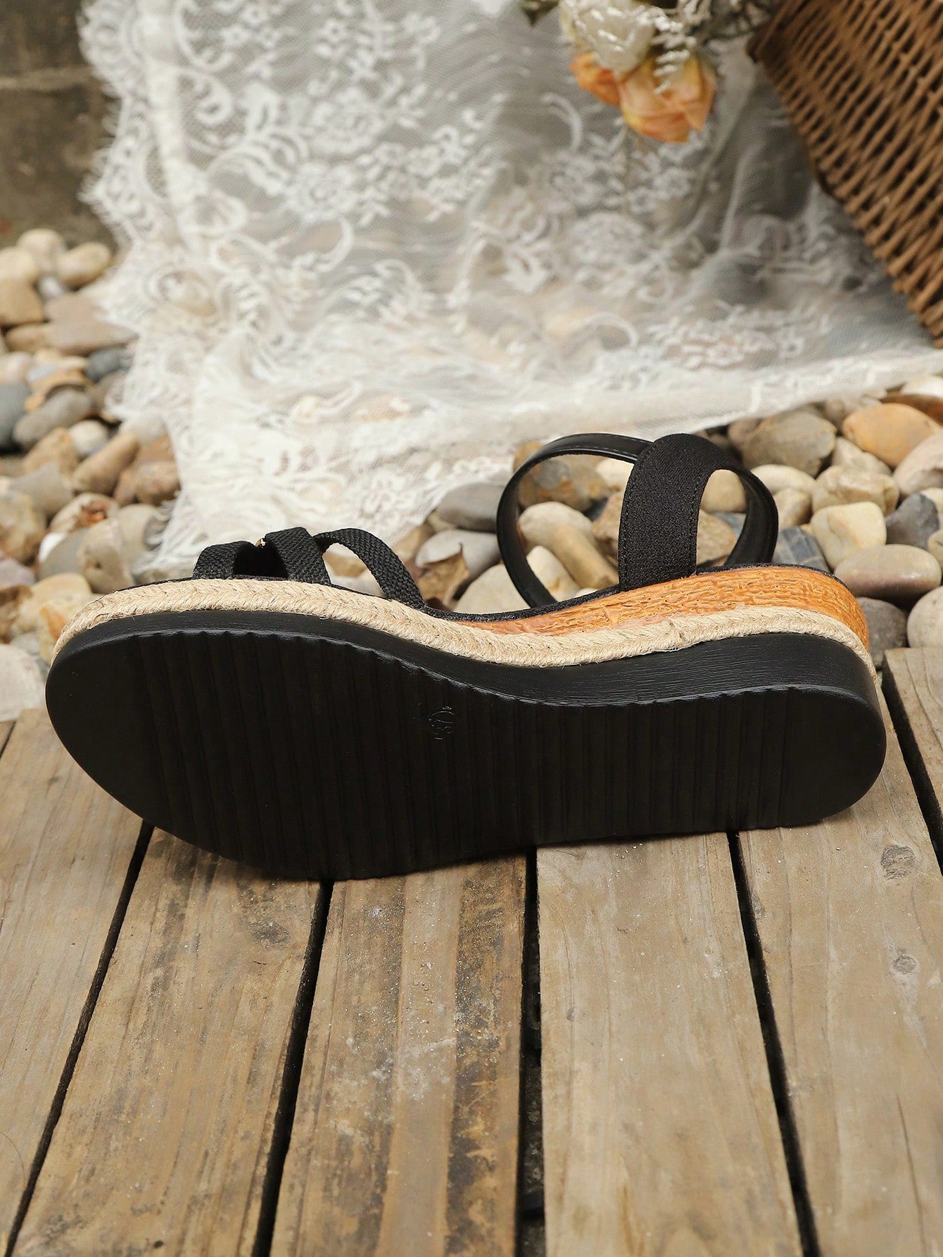 Women’s open-toe wedge sandals with a woven platform-style sole, ankle buckle strap, and mid heel, shown in a casual outdoor style.