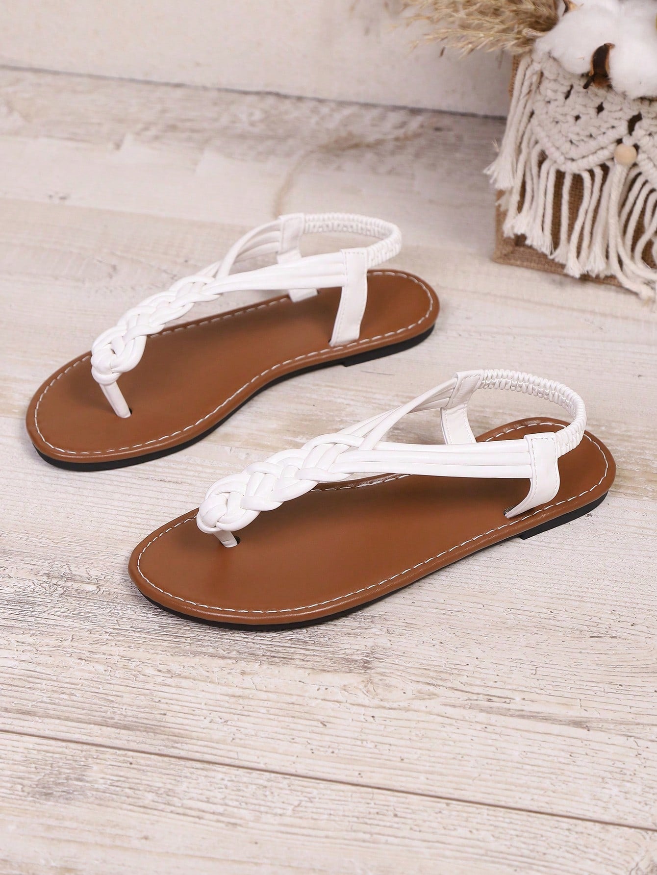 Open-toe flat slide sandals featuring rhinestone leaf decoration in a vacation-inspired style.