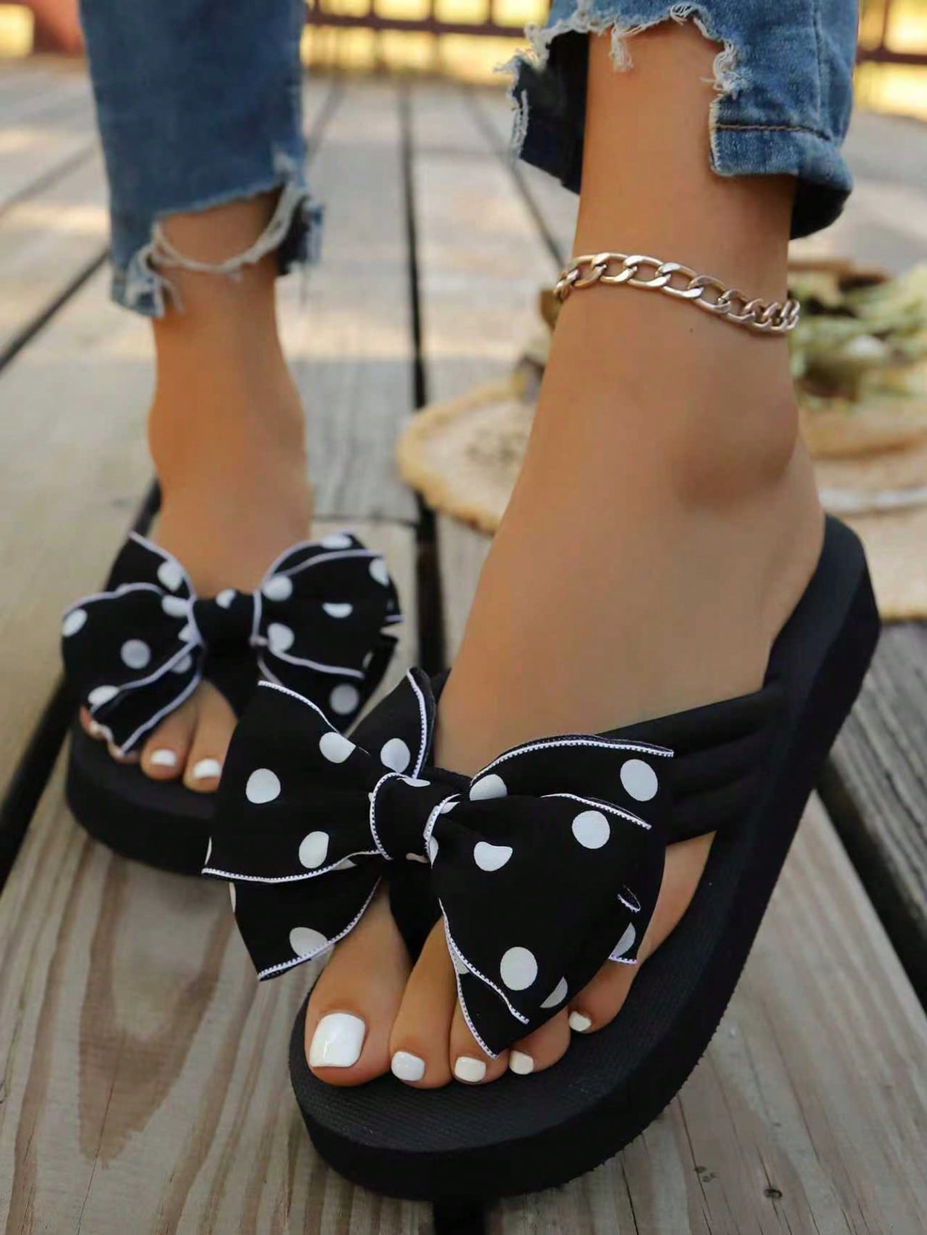 Srendia women's flip flops with polka dot bow detail, flat non-slip sole, and fabric upper for beach, vacation, home, and outdoor wear.