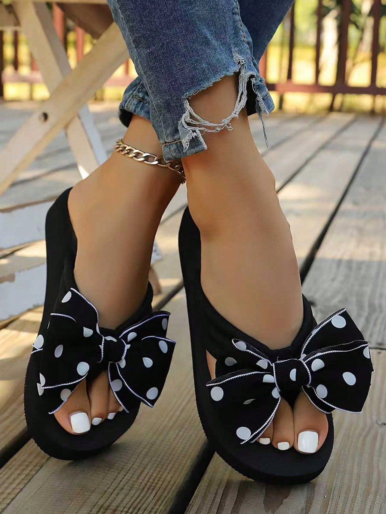 Srendia women's flip flops with polka dot bow detail, flat non-slip sole, and fabric upper for beach, vacation, home, and outdoor wear.