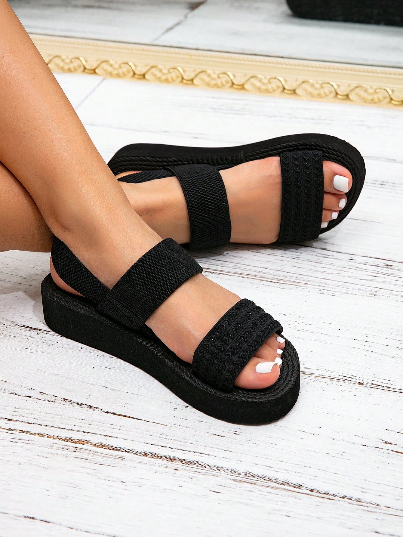 Women's black flat gladiator sandals with ruched and ruffle trim, textured fabric upper, and open-toe design for party, outdoor, and casual wear.