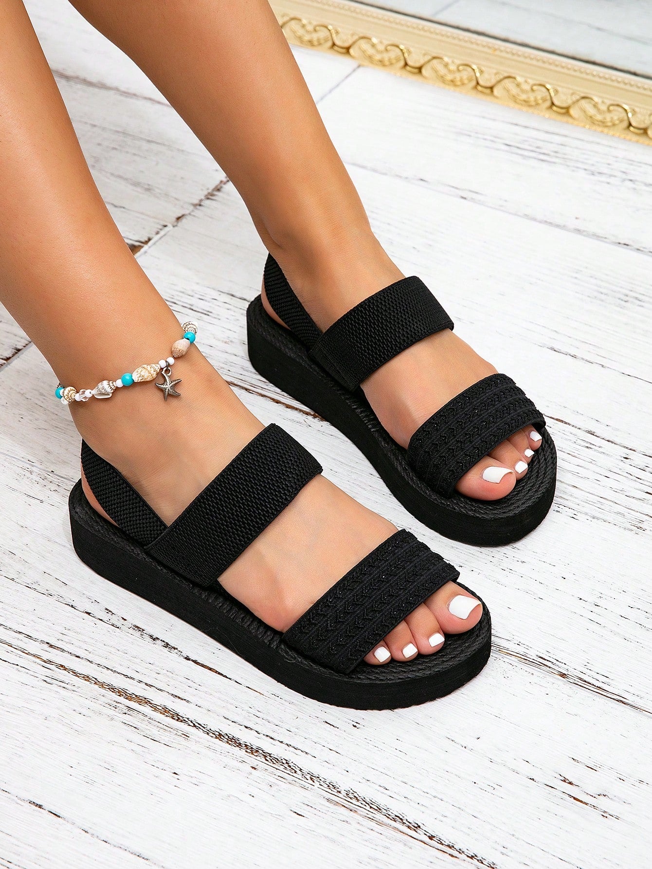 Women's black flat gladiator sandals with ruched and ruffle trim, textured fabric upper, and open-toe design for party, outdoor, and casual wear.
