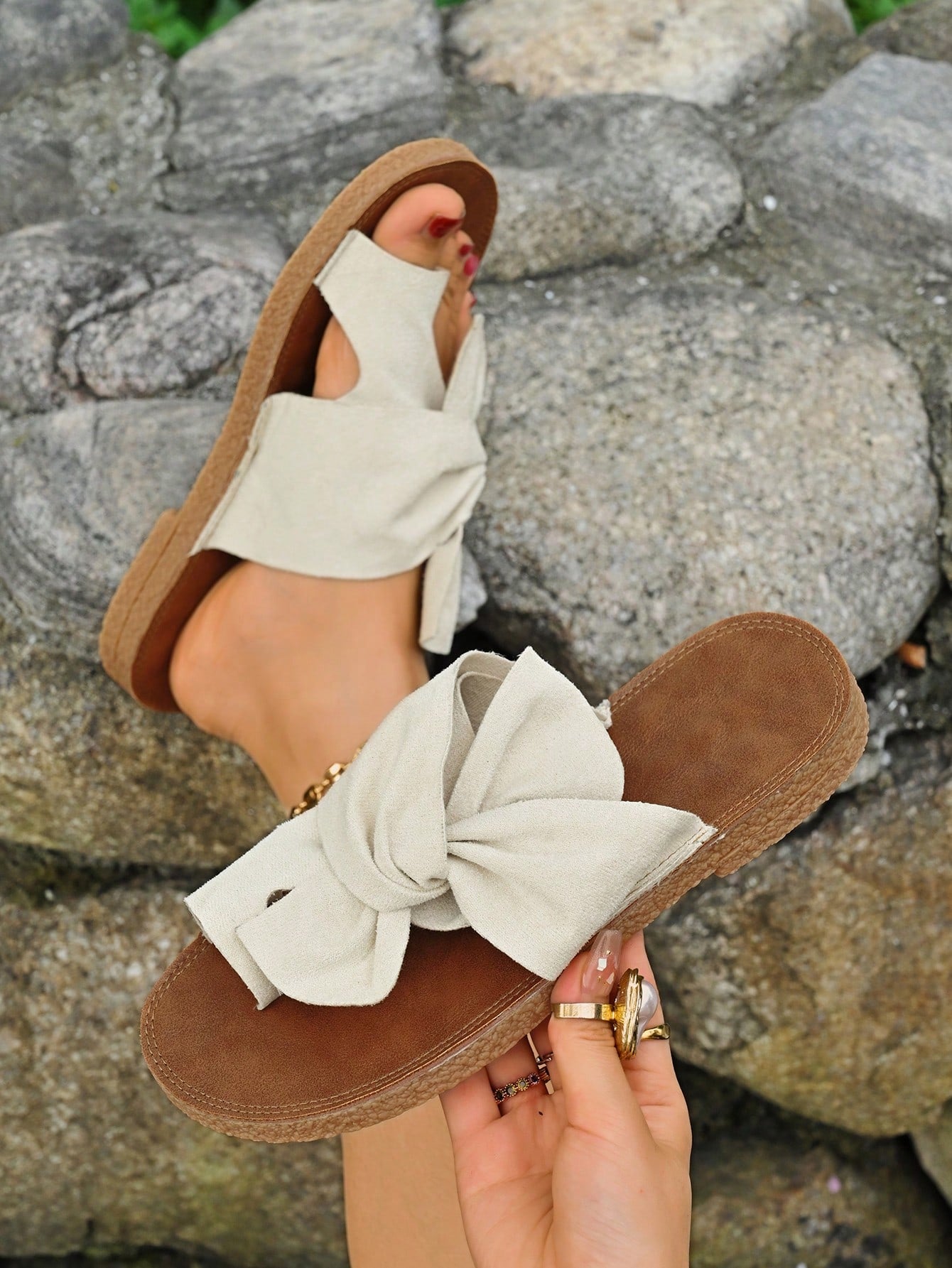 Women's flat slide sandals with bow tie, knot, and braided details, toe post design, and bohemian plant pattern.