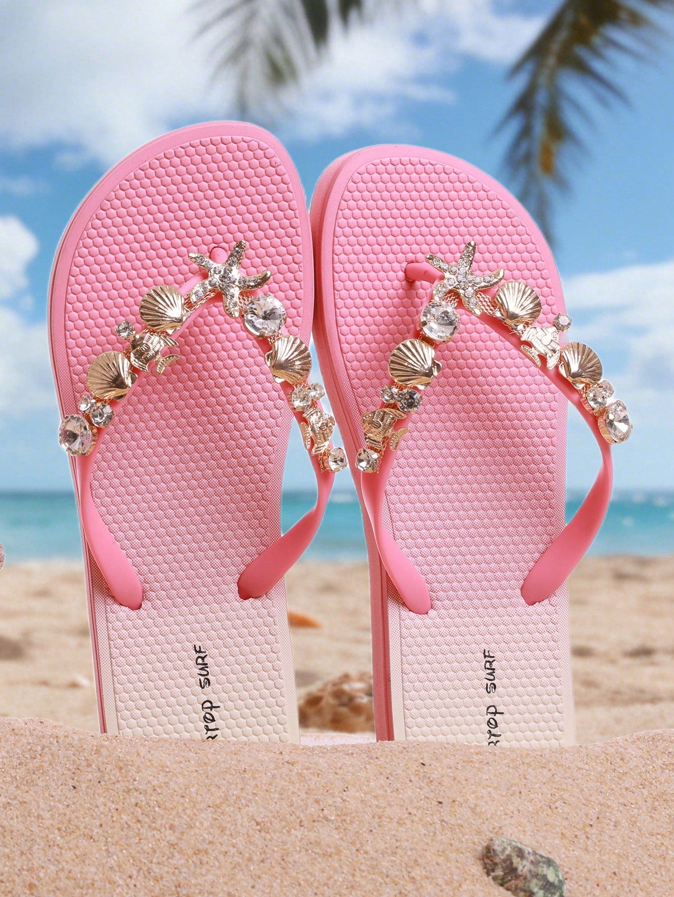 Women’s fashion flip flops with thong strap, beaded shell chain decoration, and removable decor chain detail, designed with a soft flat sole for beach and vacation use.
