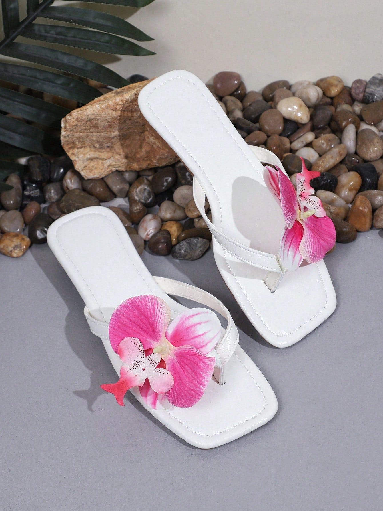 Plus size women's flat slide sandals featuring faux flower decor and a square toe, suitable for casual daily wear and beach use.