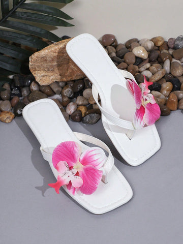 Plus size women's flat slide sandals featuring faux flower decor and a square toe, suitable for casual daily wear and beach use.