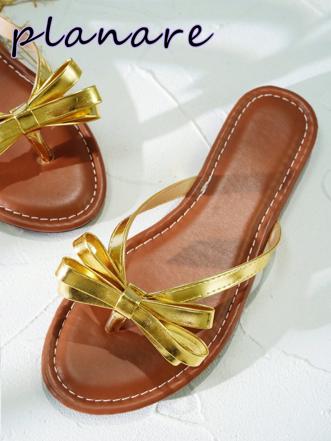 Women’s flat slide sandals with contrast mesh bow decoration and textured upper, open toe design, and slip-on style for beach and vacation wear.
