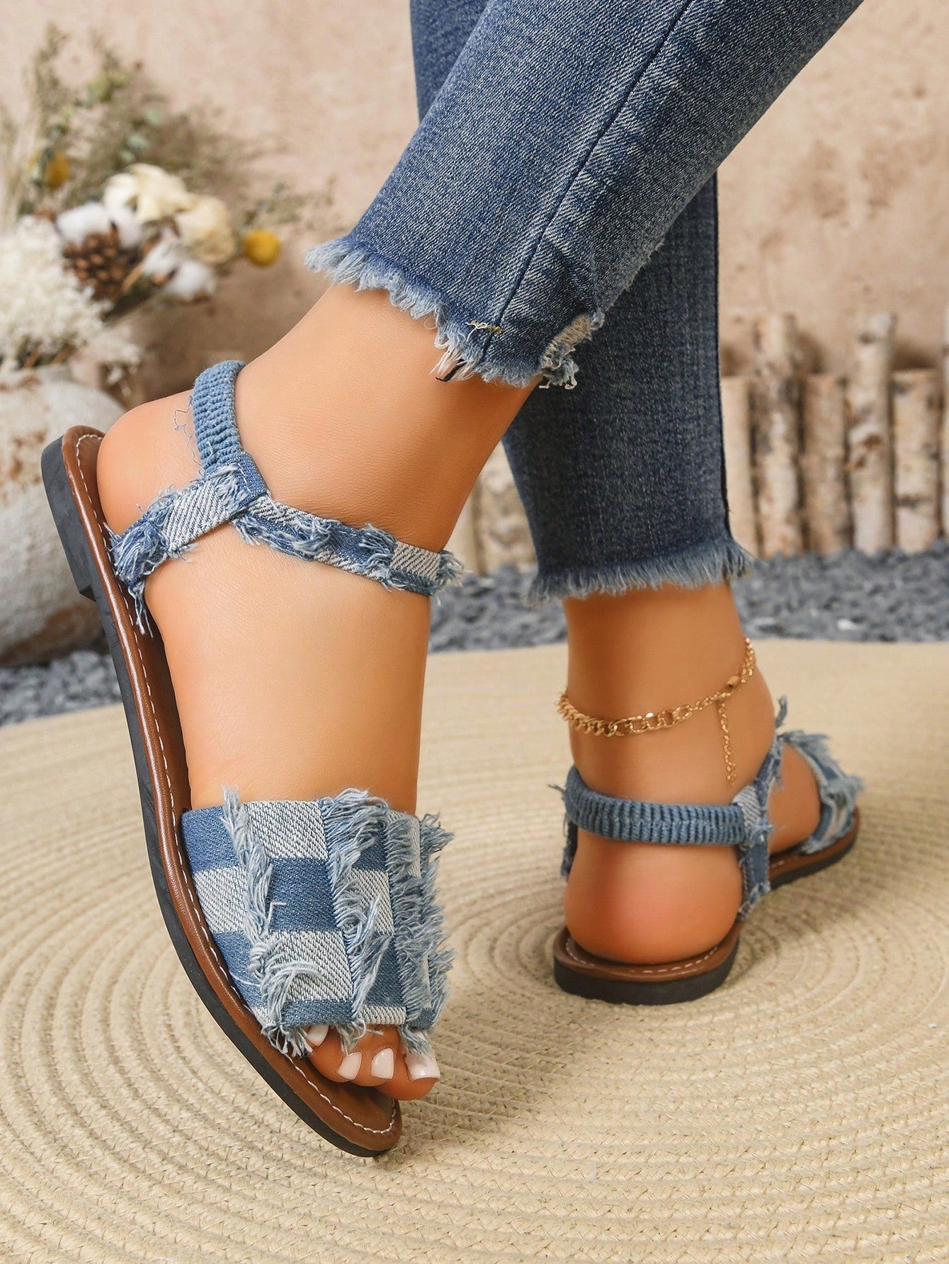 Women’s blue flat gladiator sandals with buckle and criss cross straps, round toe, and plaid pattern, styled as casual woven beach slippers.