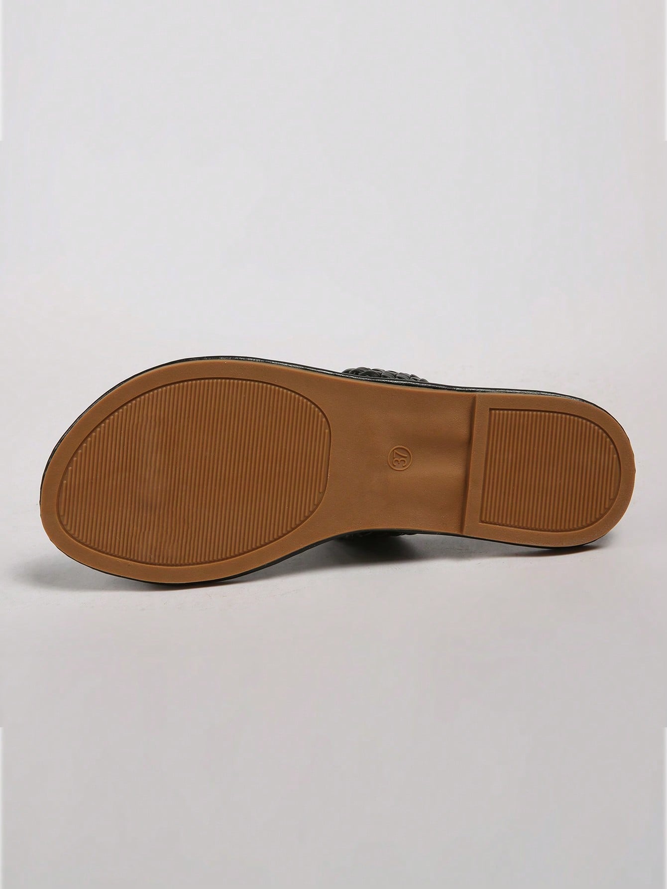 Plus size women's solid gold flat slide sandals with thin criss cross straps, round toe shape, and toe post detail, shown in a lightweight beach-style slip-on design.