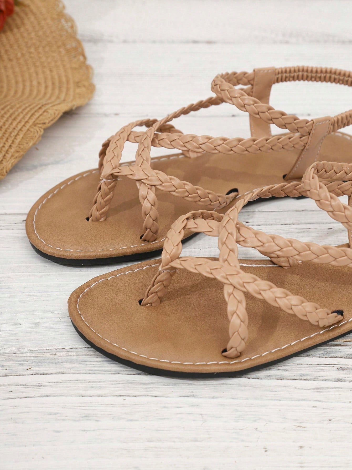 Women's woven criss-cross elastic flat sandals with braided strappy upper and toe post design