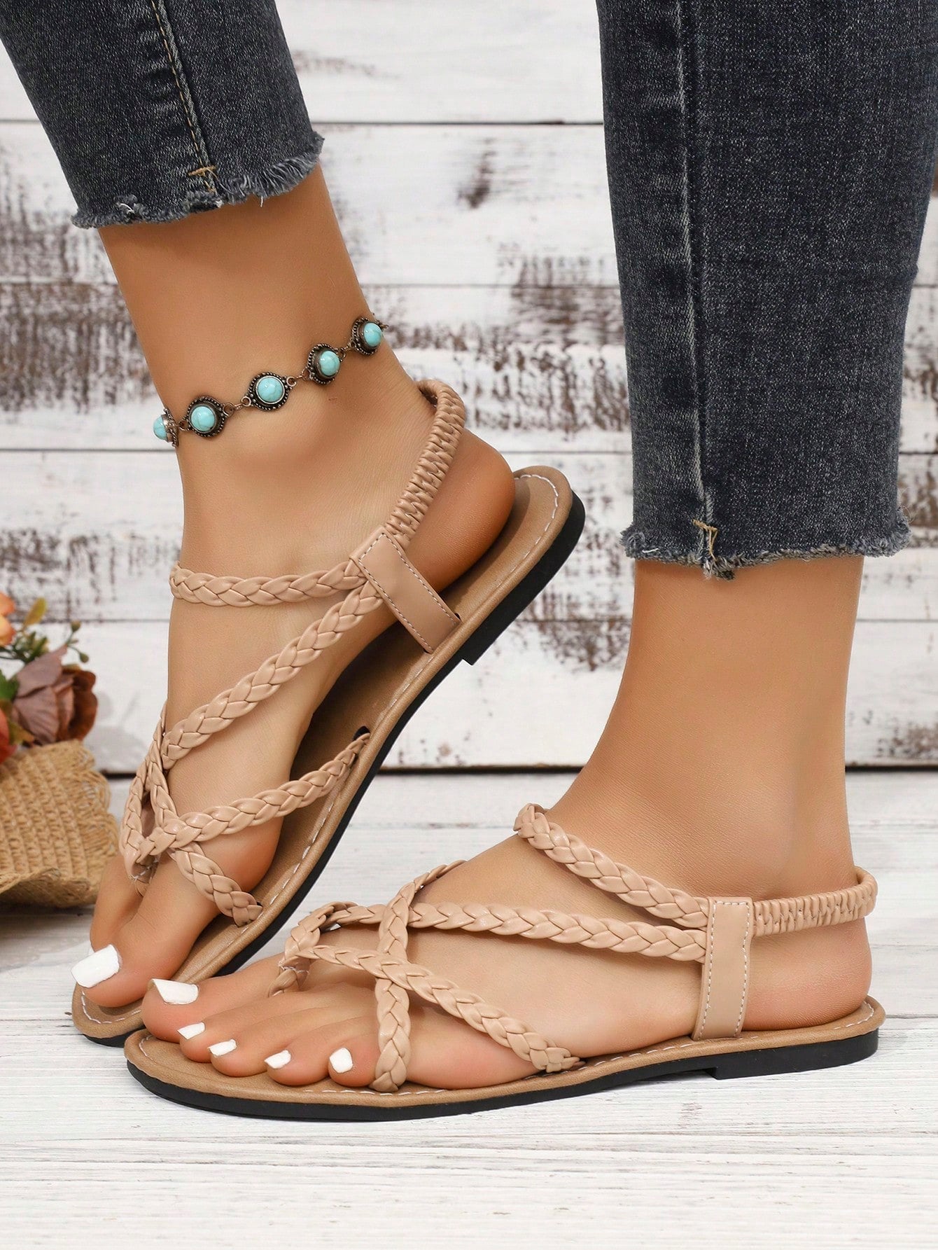 Women's woven criss-cross elastic flat sandals with braided strappy upper and toe post design