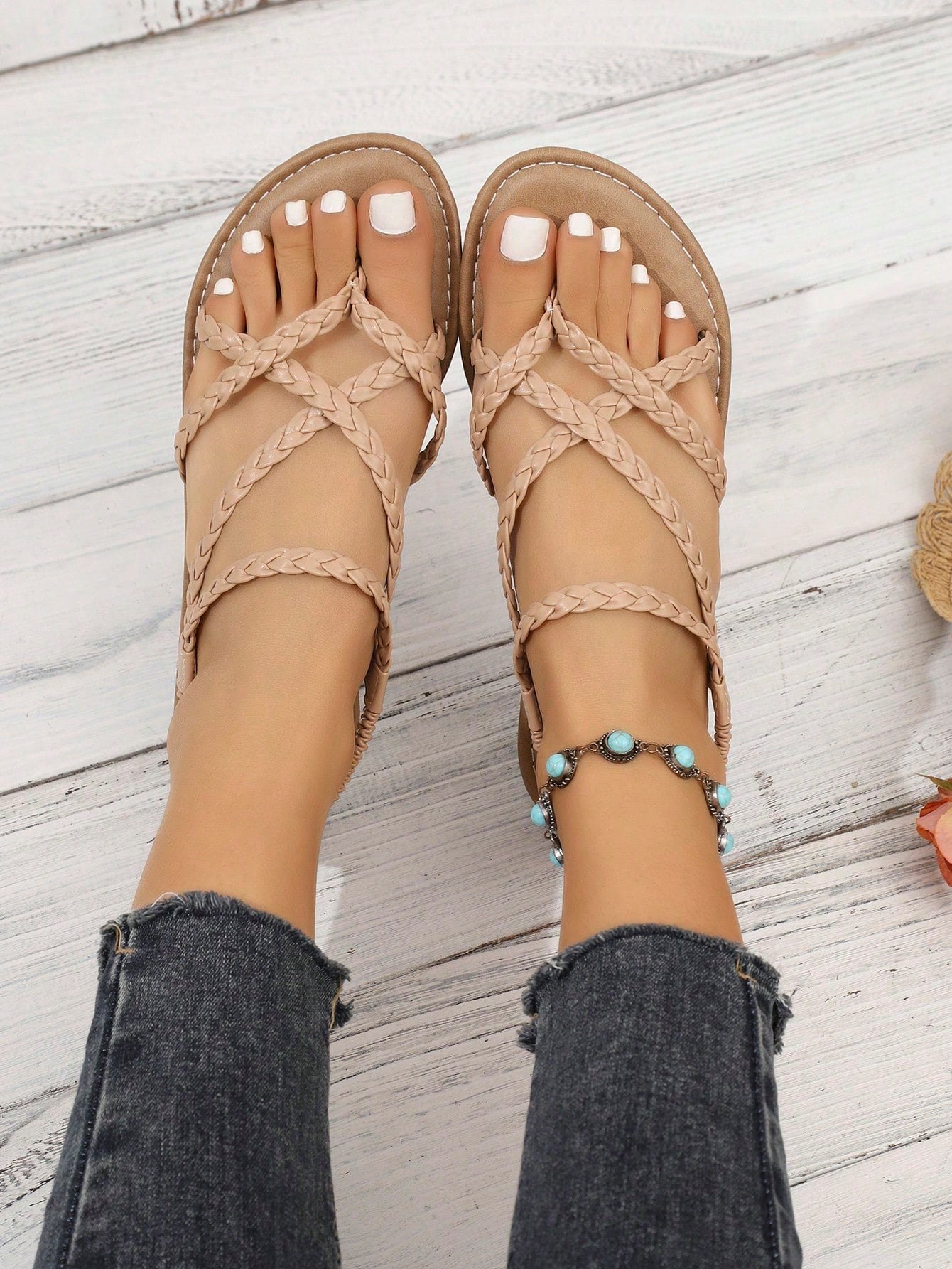 Women's woven criss-cross elastic flat sandals with braided strappy upper and toe post design