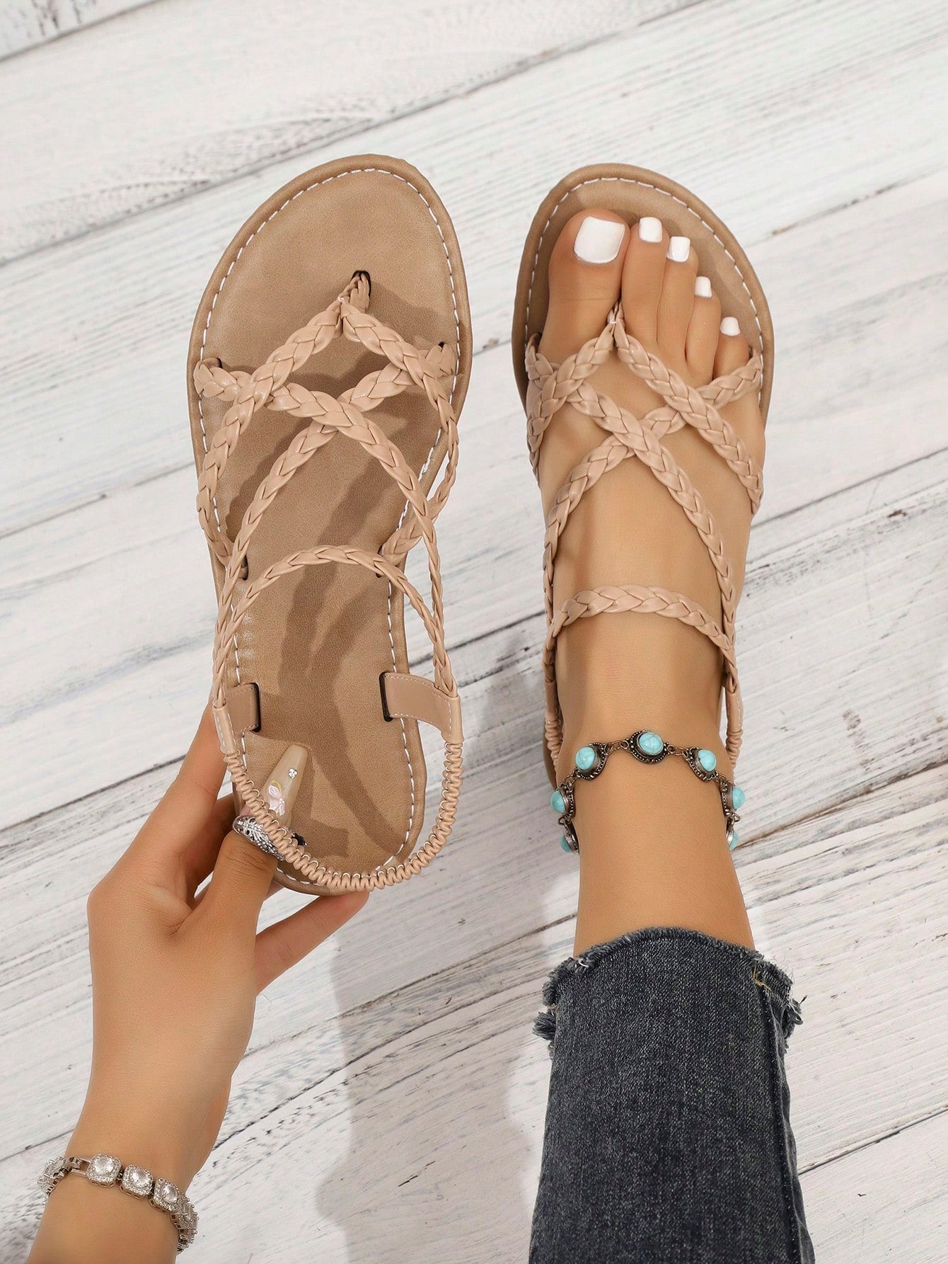 Women's woven criss-cross elastic flat sandals with braided strappy upper and toe post design