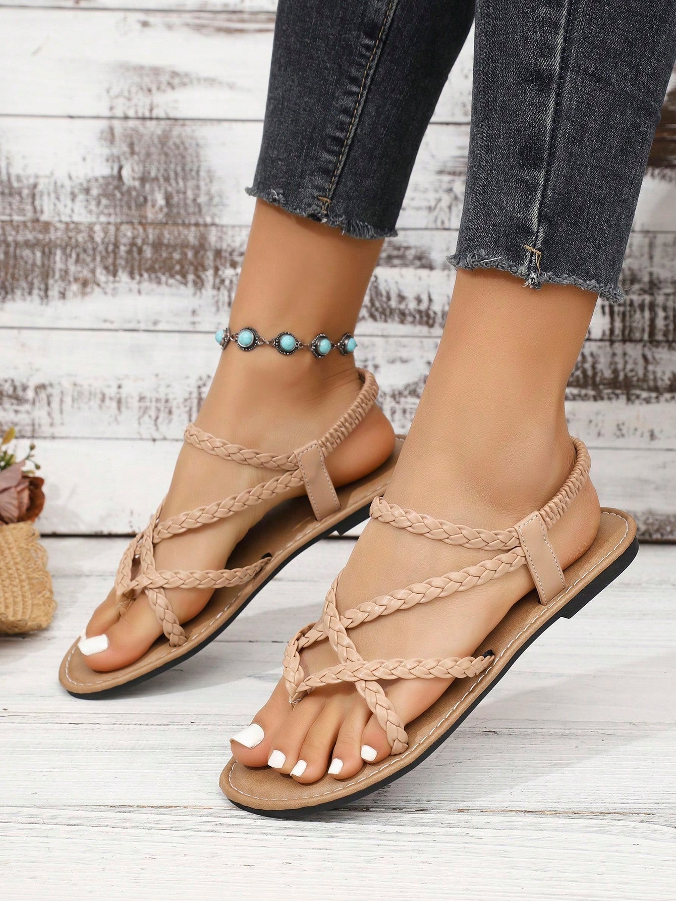 Women's woven criss-cross elastic flat sandals with braided strappy upper and toe post design