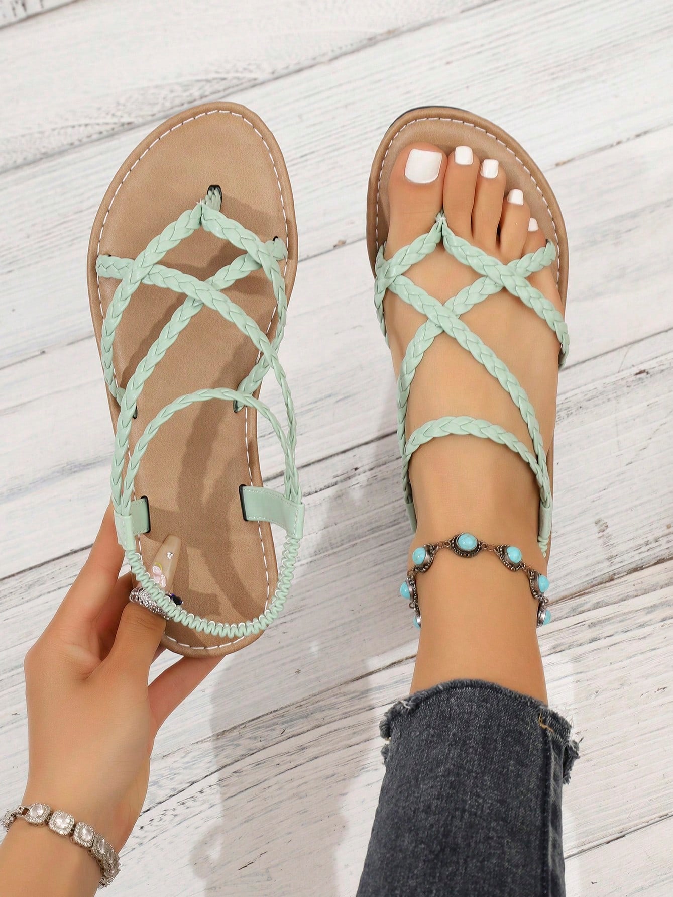Women's woven criss-cross elastic flat sandals with braided strappy upper and toe post design