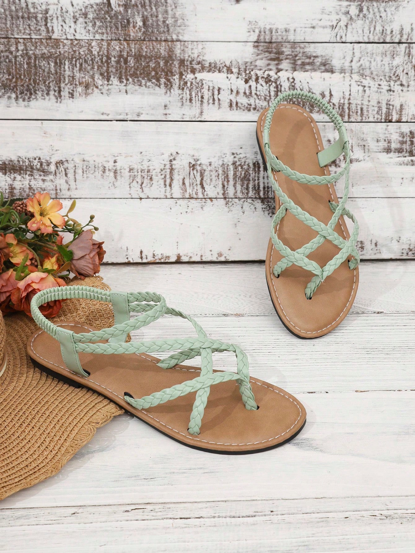 Women's woven criss-cross elastic flat sandals with braided strappy upper and toe post design