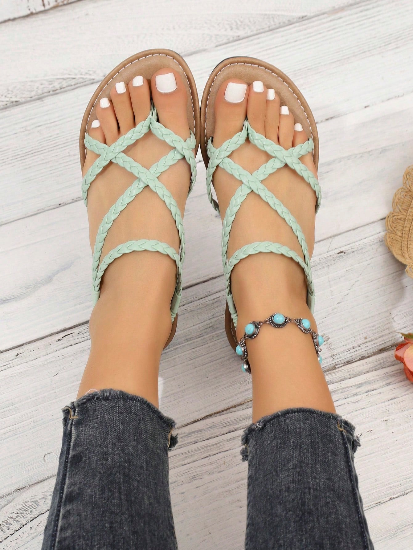 Women's woven criss-cross elastic flat sandals with braided strappy upper and toe post design