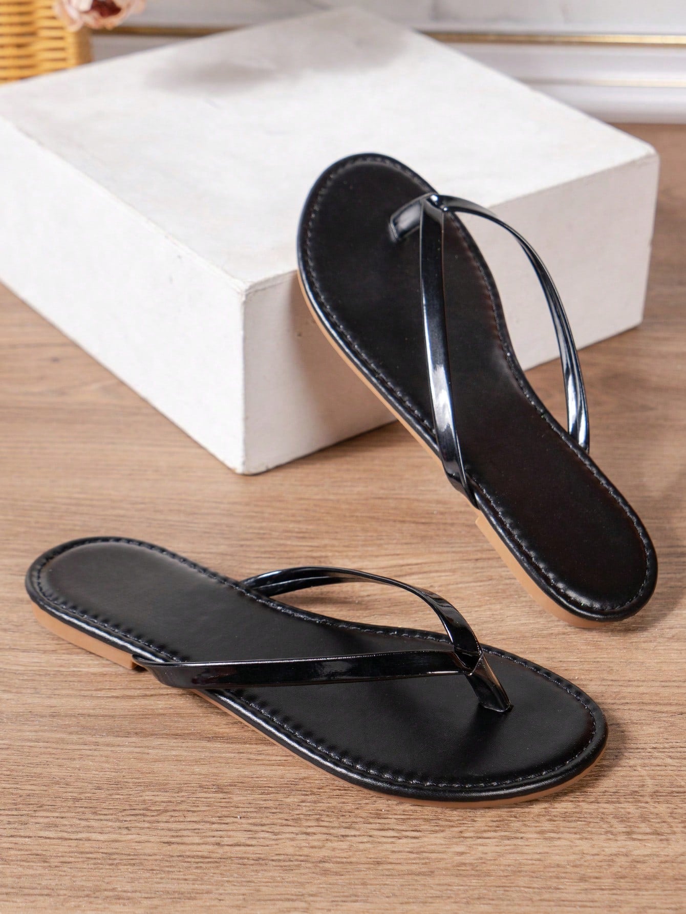 Women's criss cross thong flip flops with lace-up detail, flat sole, and non-slip outsole, suitable for beach, holiday, and casual walking wear.