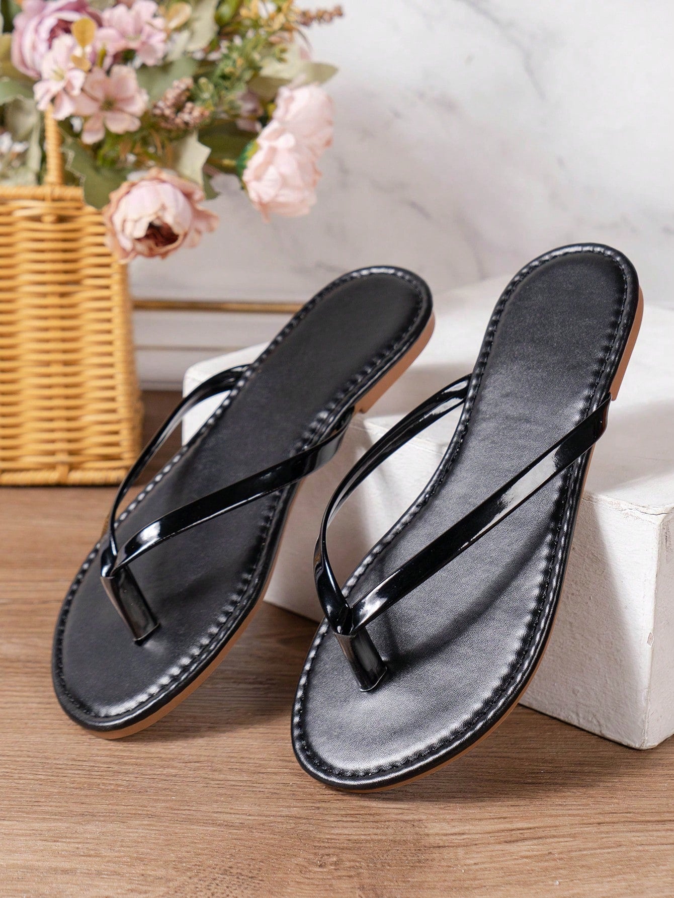 Women's criss cross thong flip flops with lace-up detail, flat sole, and non-slip outsole, suitable for beach, holiday, and casual walking wear.