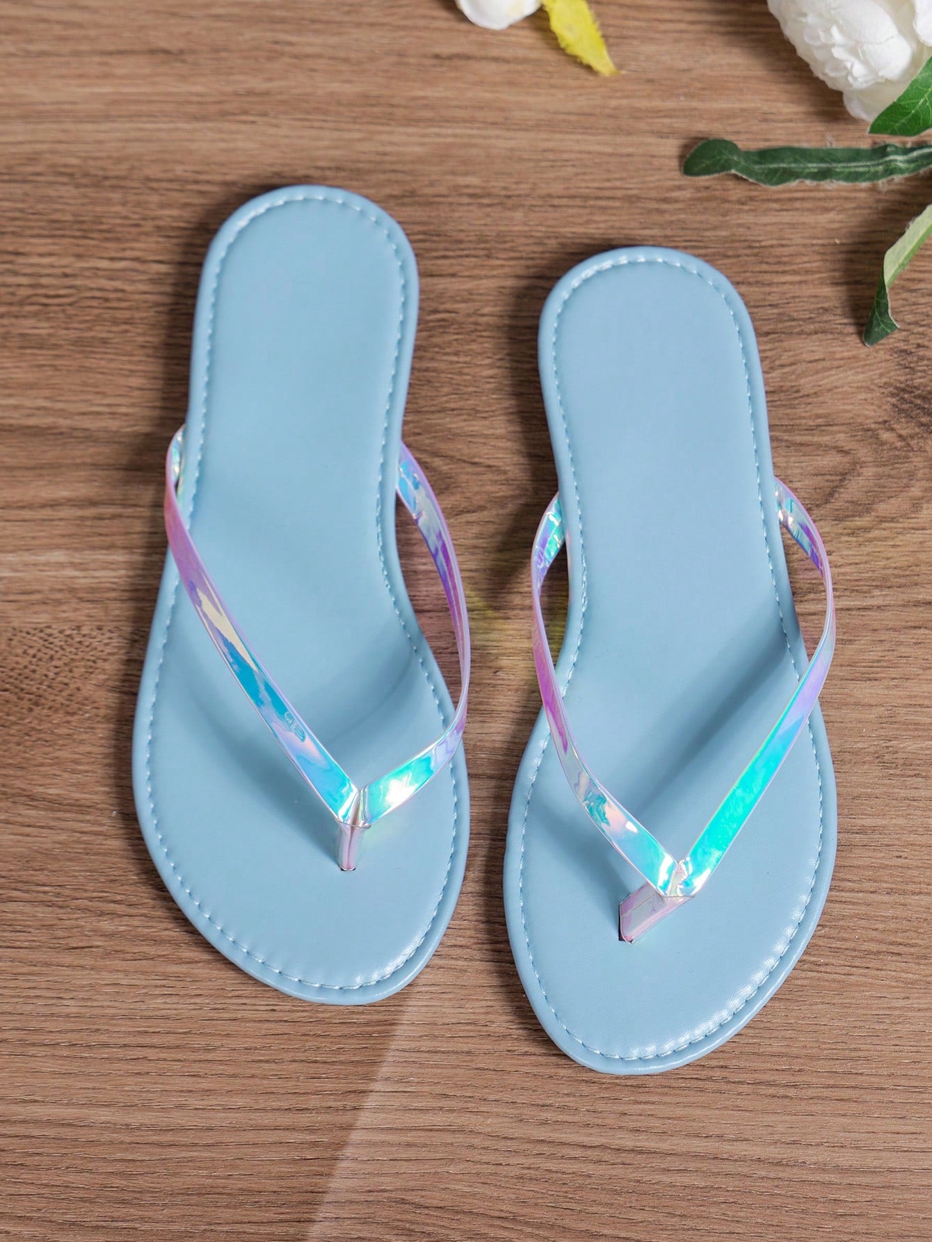 Women's criss cross thong flip flops with lace-up detail, flat sole, and non-slip outsole, suitable for beach, holiday, and casual walking wear.