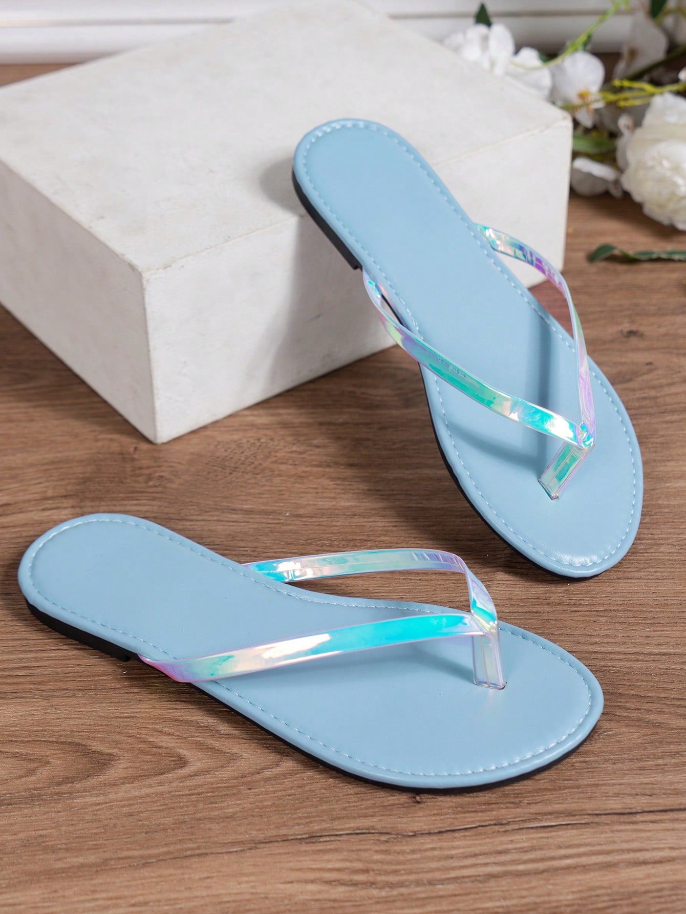Women's criss cross thong flip flops with lace-up detail, flat sole, and non-slip outsole, suitable for beach, holiday, and casual walking wear.