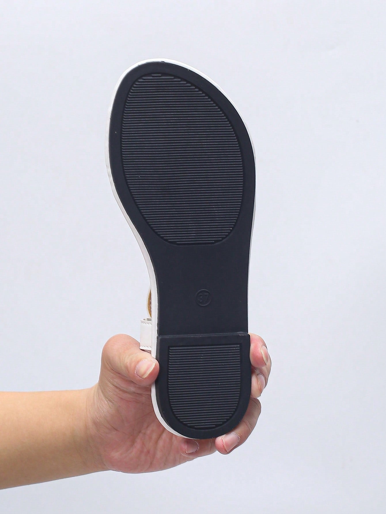 Women’s plus size 35-45 flat thong sandals with elastic strap, round toe shape, textured pattern, and rhinestone asymmetrical detail in slip-on beach style for outdoor summer wear.