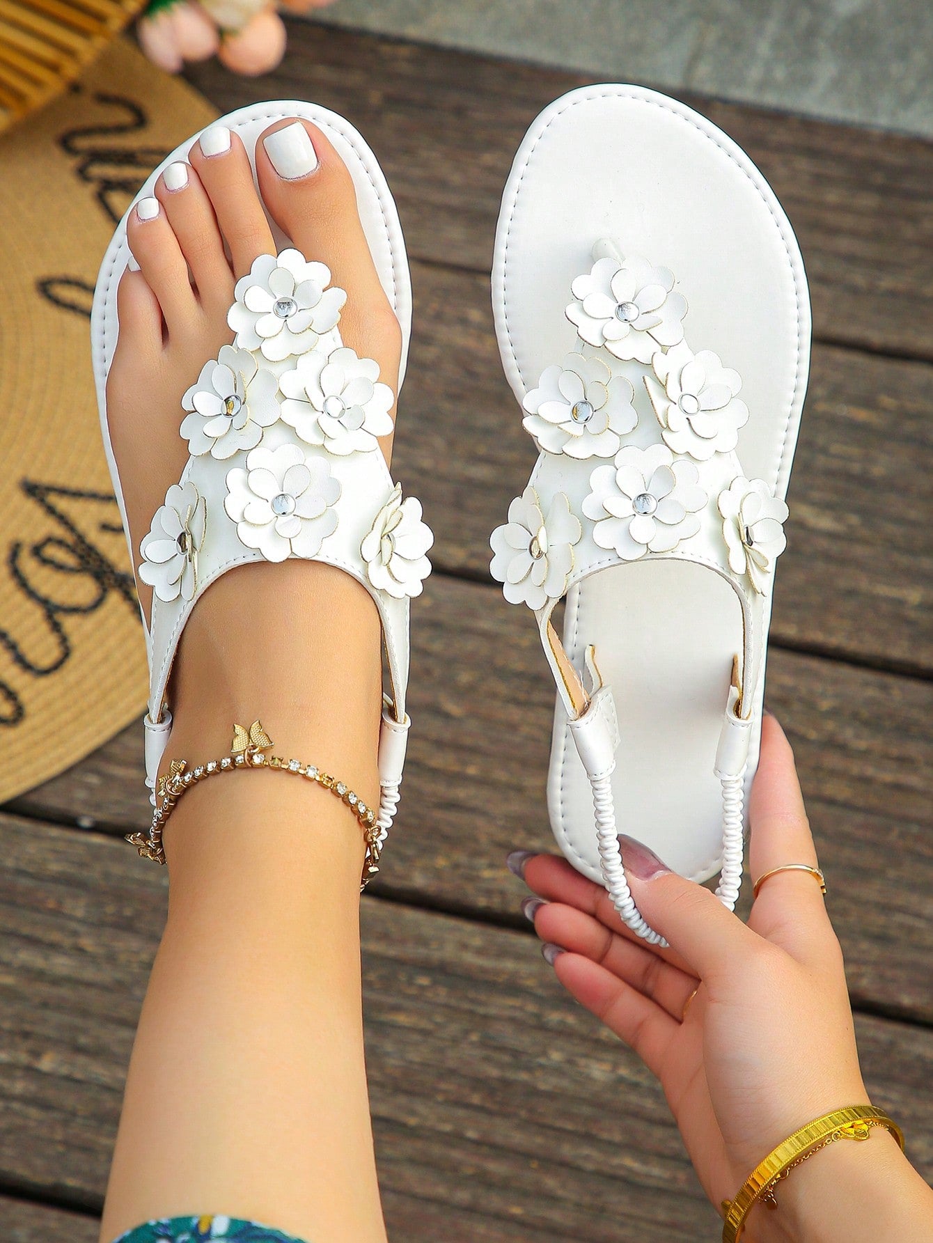 Women’s plus size 35-45 flat thong sandals with elastic strap, round toe shape, textured pattern, and rhinestone asymmetrical detail in slip-on beach style for outdoor summer wear.