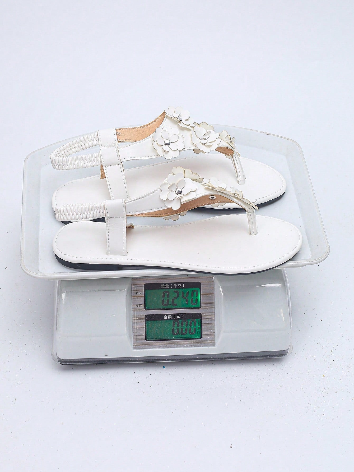 Women’s plus size 35-45 flat thong sandals with elastic strap, round toe shape, textured pattern, and rhinestone asymmetrical detail in slip-on beach style for outdoor summer wear.