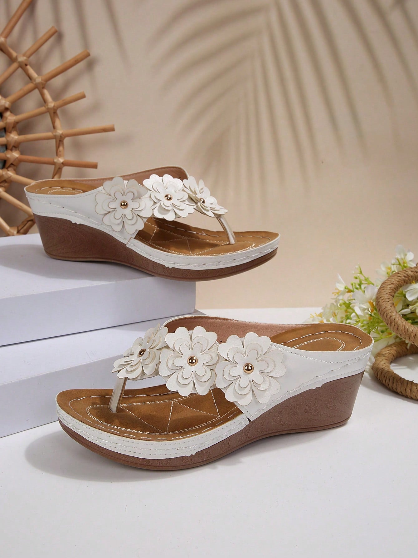 Women's gold platform flip flop wedge sandals with toe post and textured flower detail, slip-on vacation slide style with mid heel.