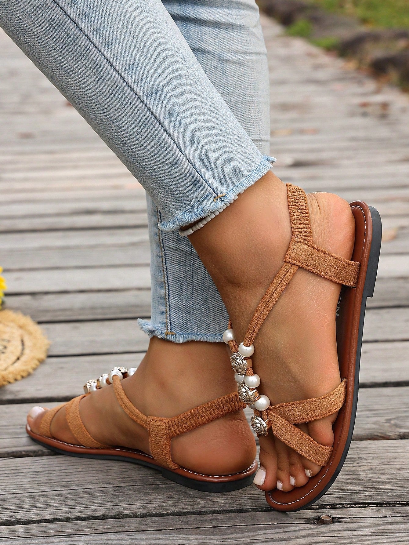 Women's beaded open-toe thong flat sandals in slip-on style for outdoor and beach casual wear.