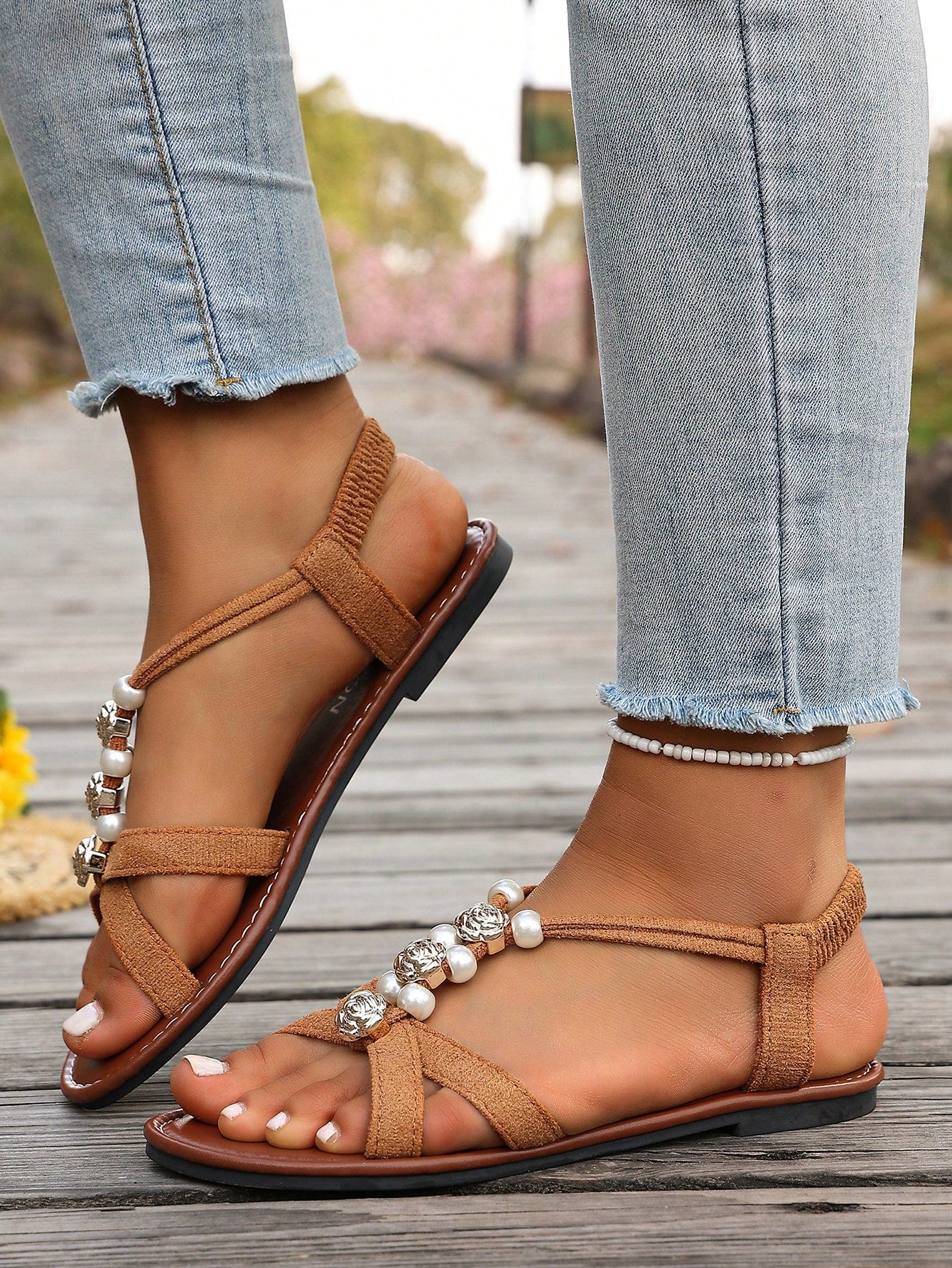 Women's beaded open-toe thong flat sandals in slip-on style for outdoor and beach casual wear.