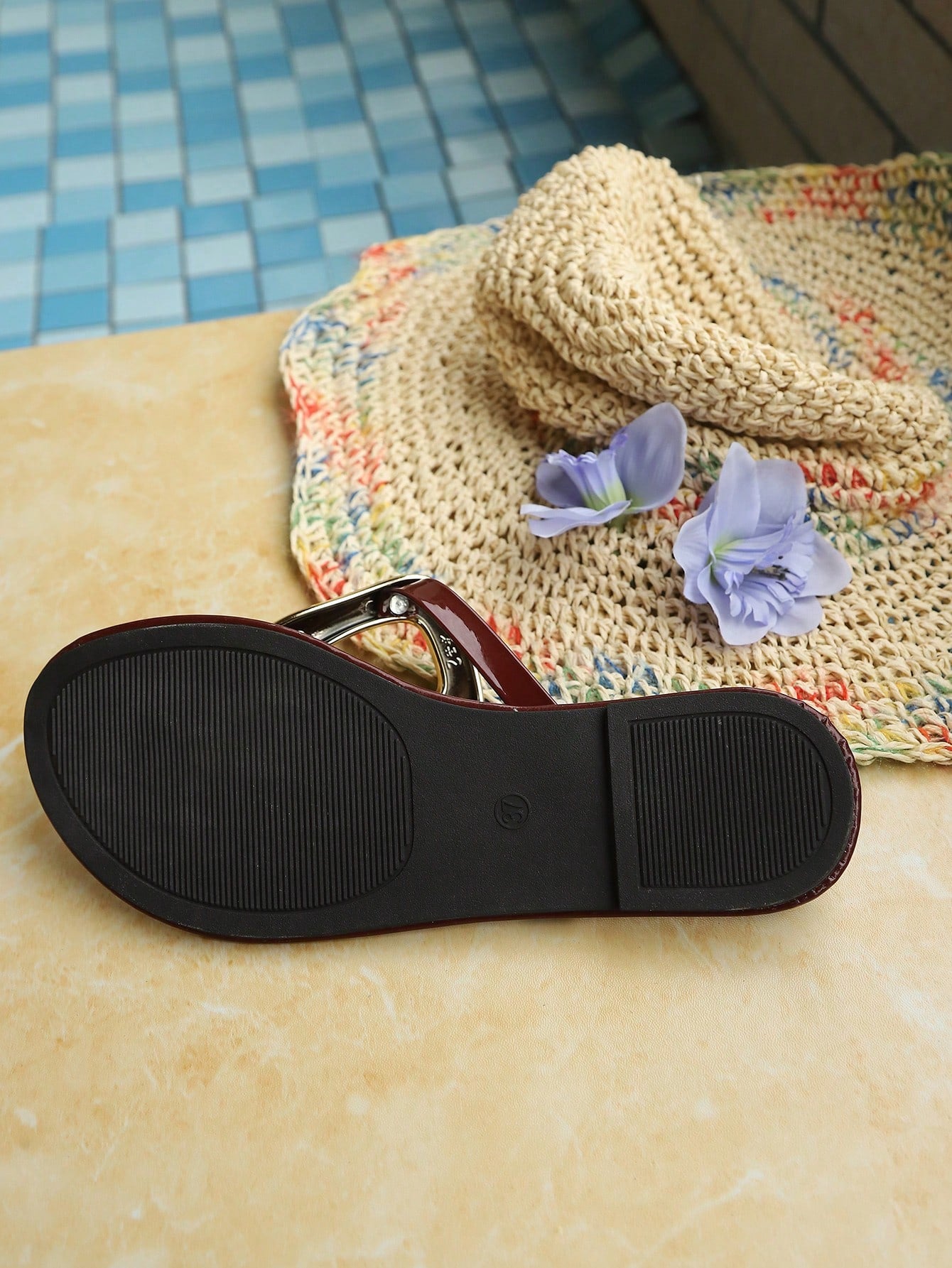 Women’s gold flat slide sandals with open toe post design and metal buckle detail, shown as fashionable outdoor summer footwear.