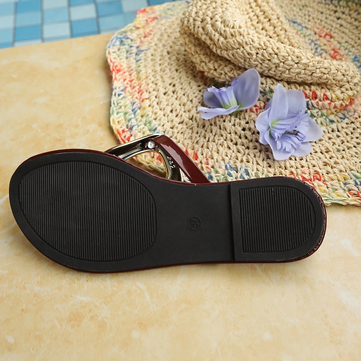 Women’s gold flat slide sandals with open toe post design and metal buckle detail, shown as fashionable outdoor summer footwear.