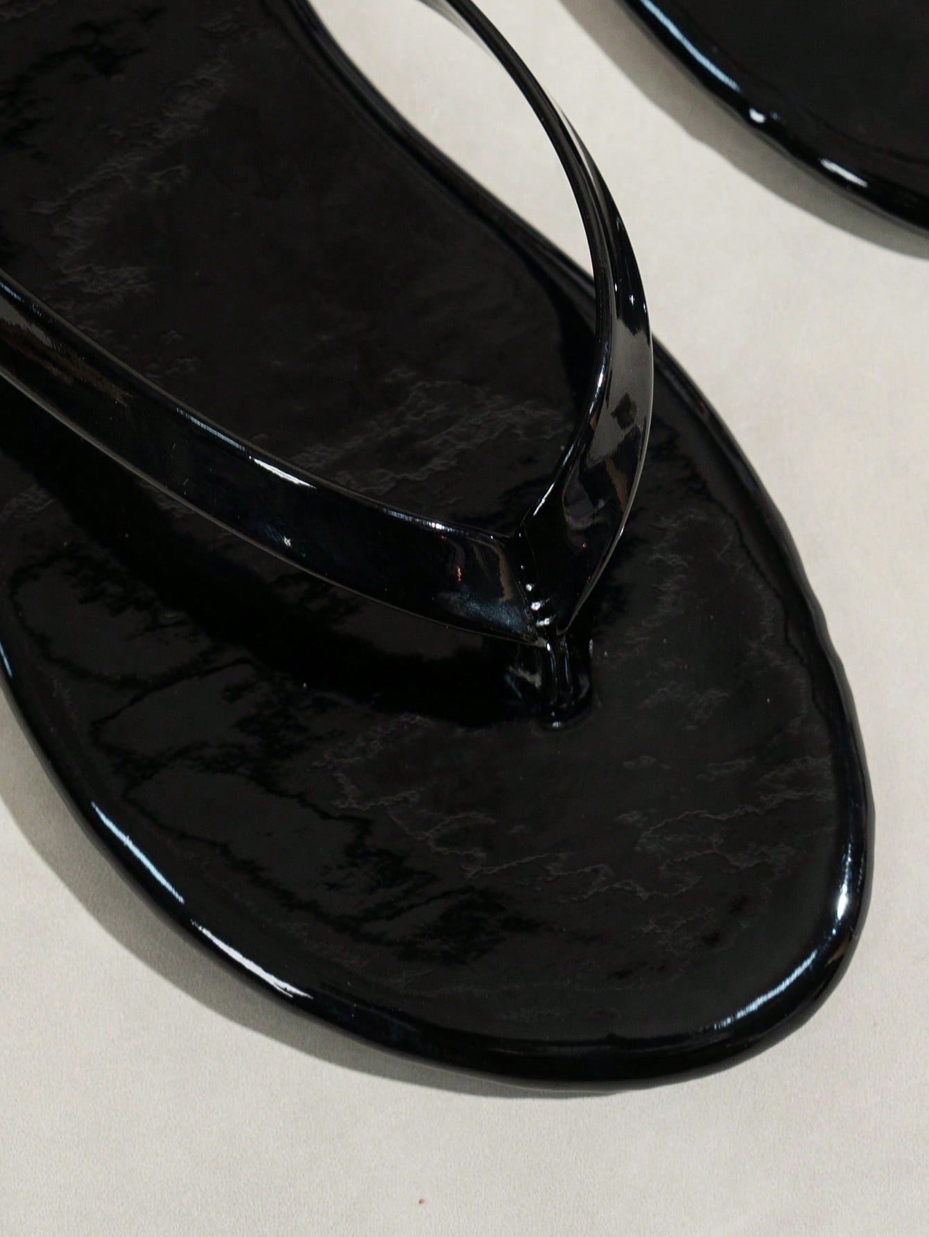 Women's shiny flat flip flop slide sandals with criss cross straps and round toe, suitable for beach, travel, home, and casual outings.