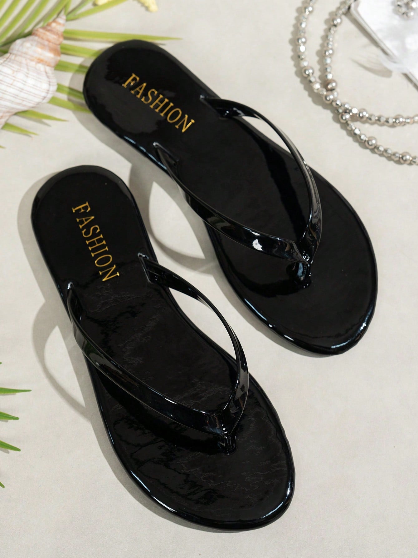 Women's shiny flat flip flop slide sandals with criss cross straps and round toe, suitable for beach, travel, home, and casual outings.