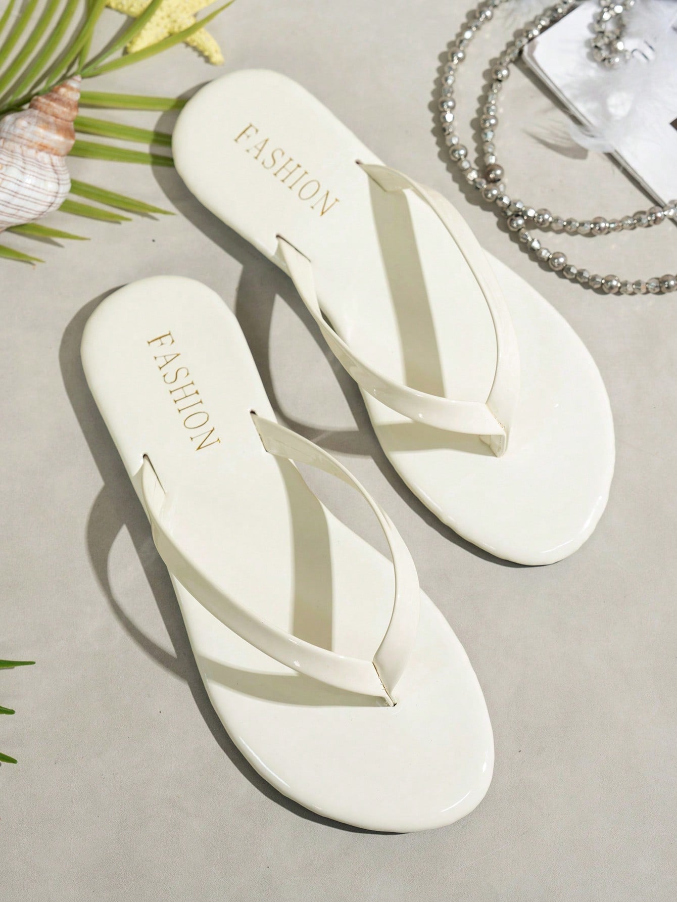 Women's shiny flat flip flop slide sandals with criss cross straps and round toe, suitable for beach, travel, home, and casual outings.