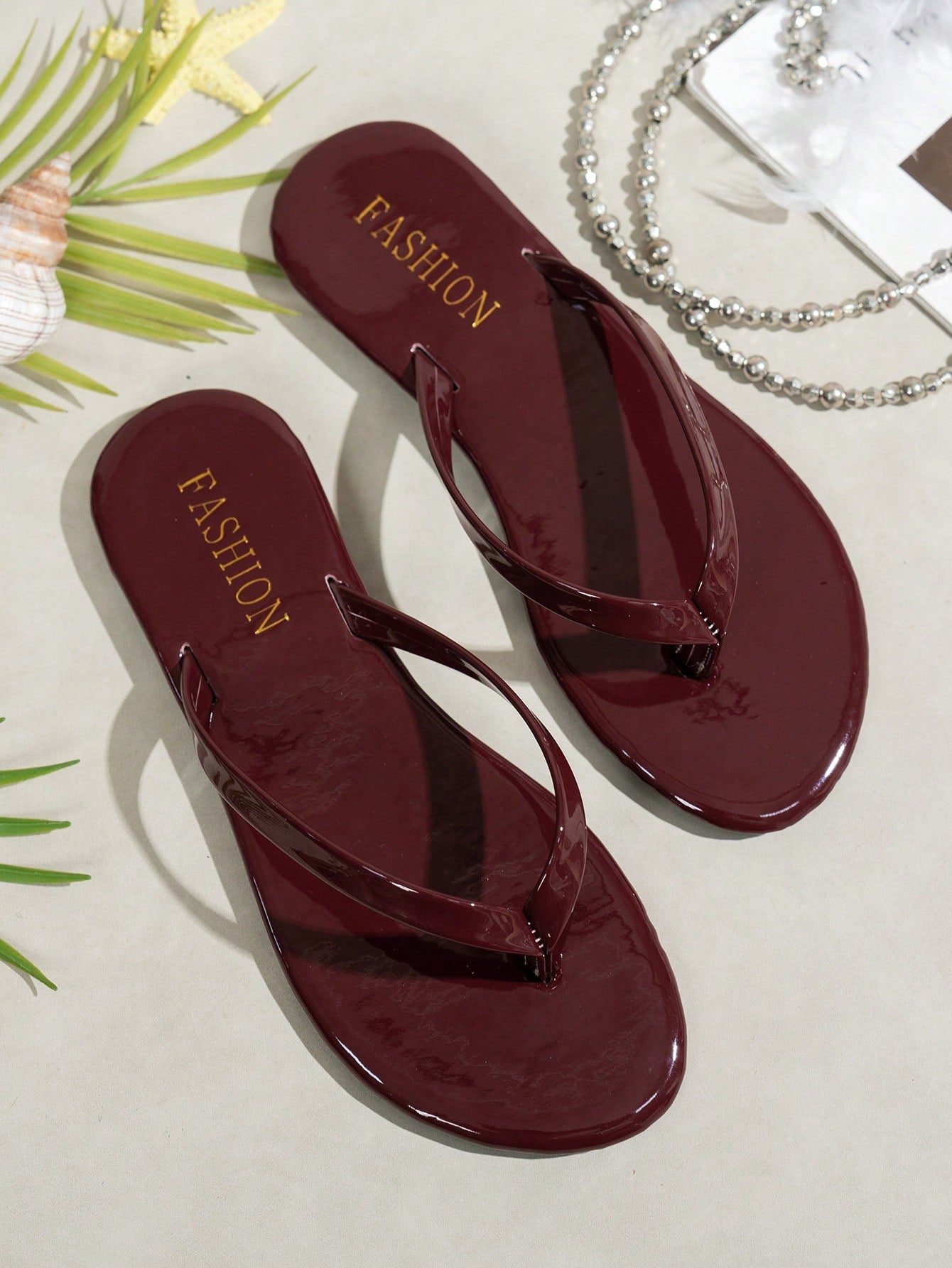 Women's shiny flat flip flop slide sandals with criss cross straps and round toe, suitable for beach, travel, home, and casual outings.
