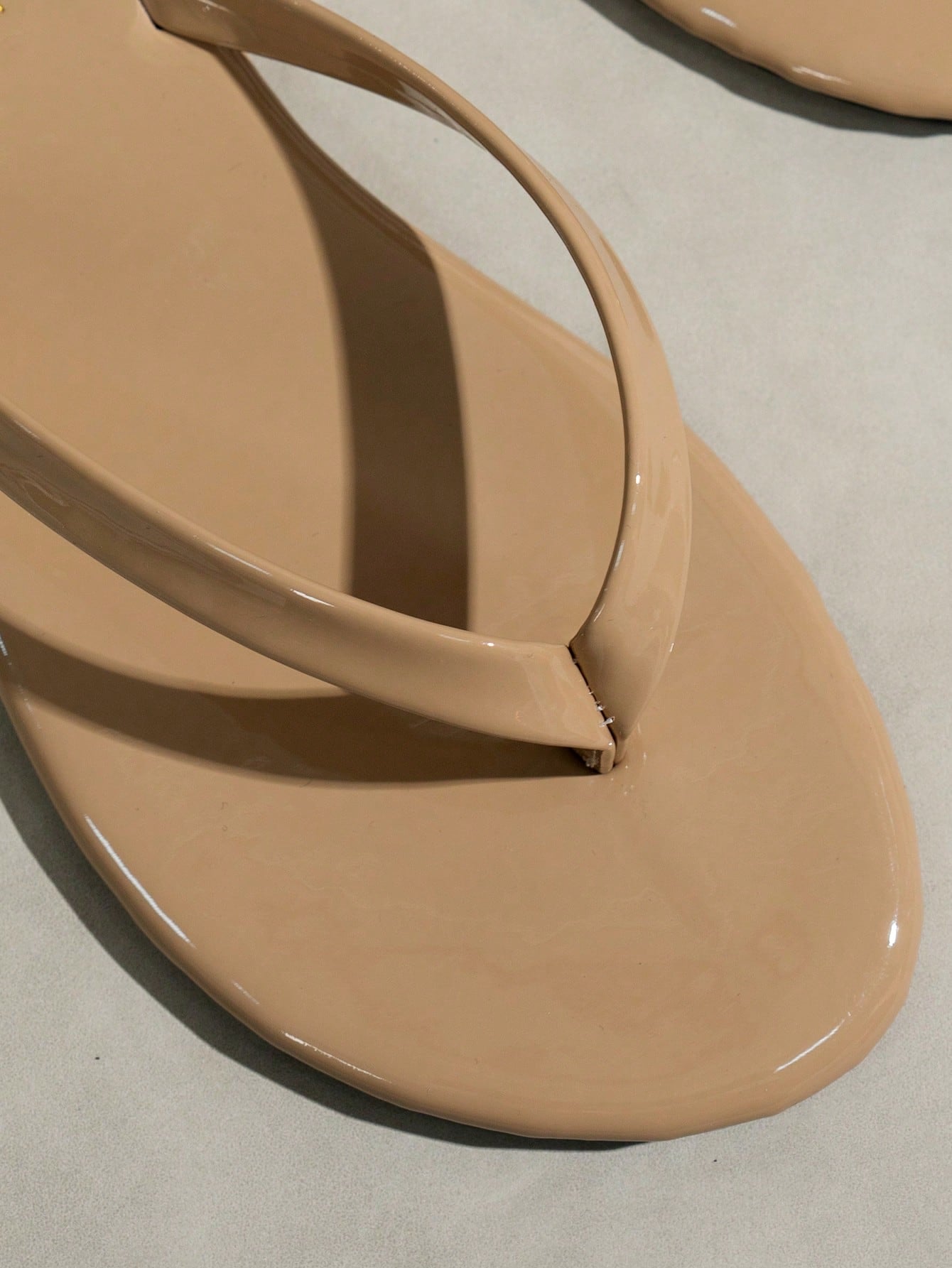 Women's shiny flat flip flop slide sandals with criss cross straps and round toe, suitable for beach, travel, home, and casual outings.