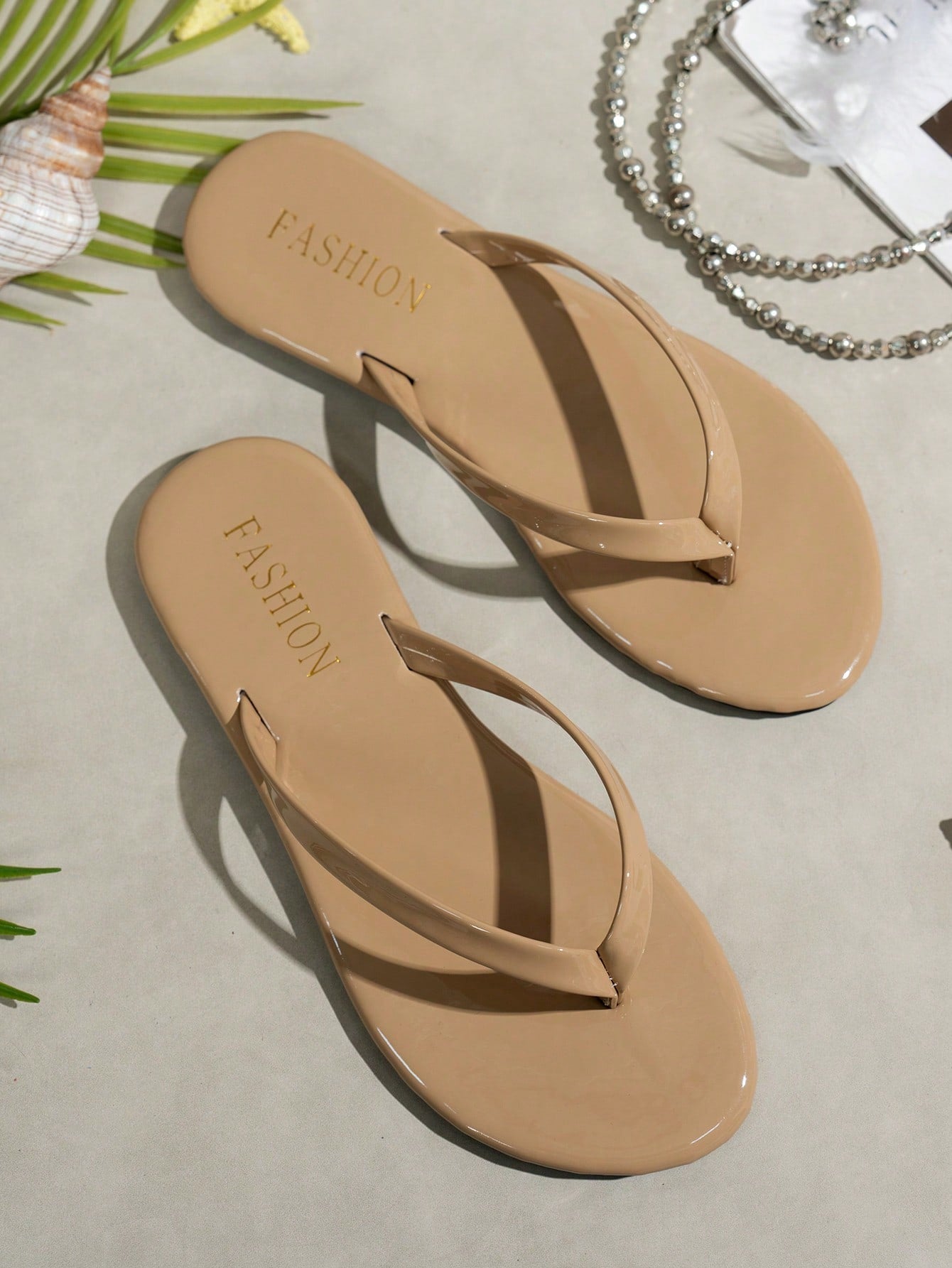 Women's shiny flat flip flop slide sandals with criss cross straps and round toe, suitable for beach, travel, home, and casual outings.