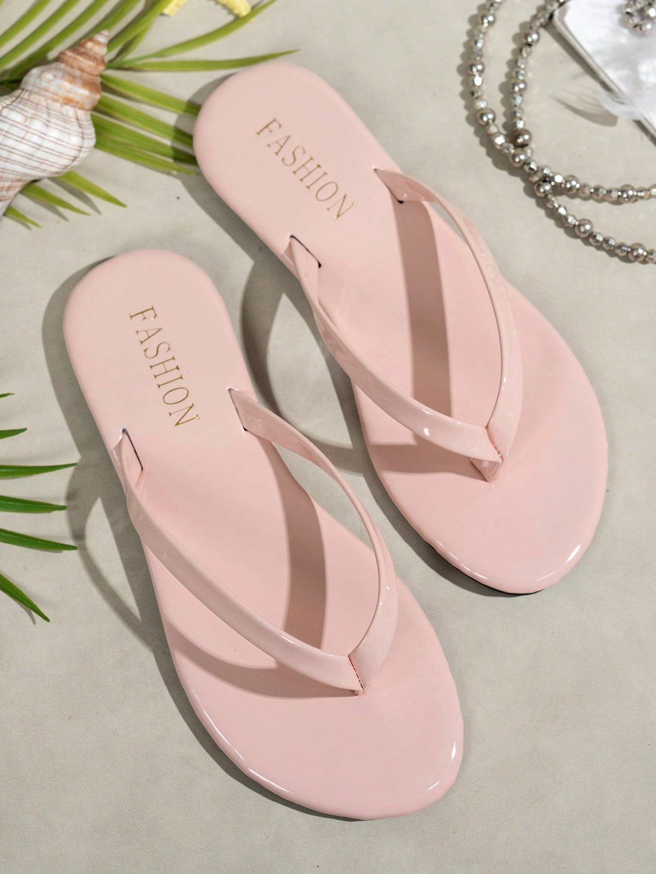 Women's shiny flat flip flop slide sandals with criss cross straps and round toe, suitable for beach, travel, home, and casual outings.
