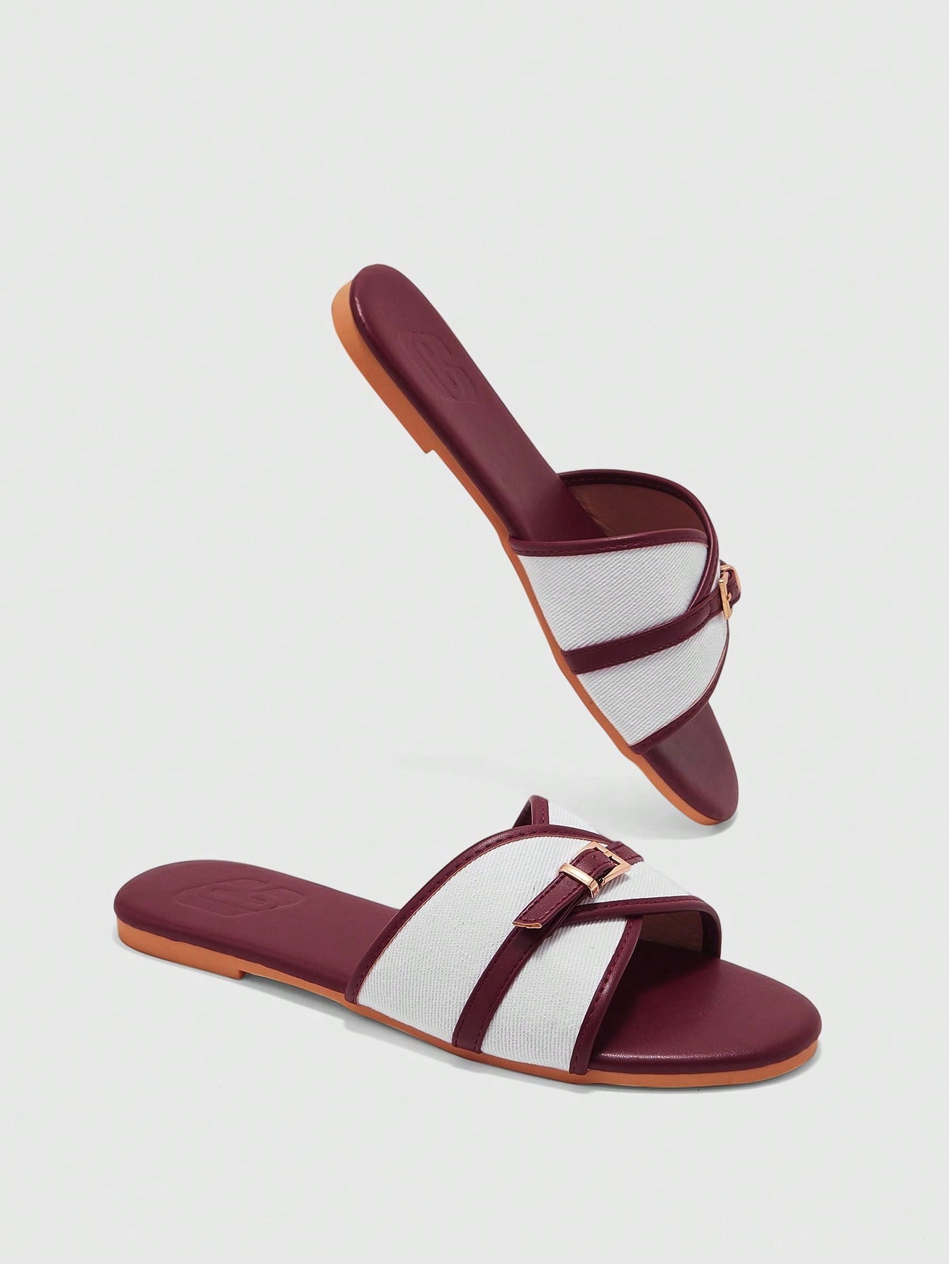 Women's flat slide sandals featuring a simple buckle strap and color block design, in brown tones, with a flat sole for casual vacation and outdoor wear.