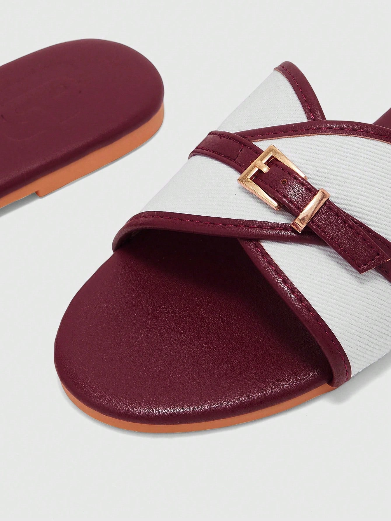 Women's flat slide sandals featuring a simple buckle strap and color block design, in brown tones, with a flat sole for casual vacation and outdoor wear.