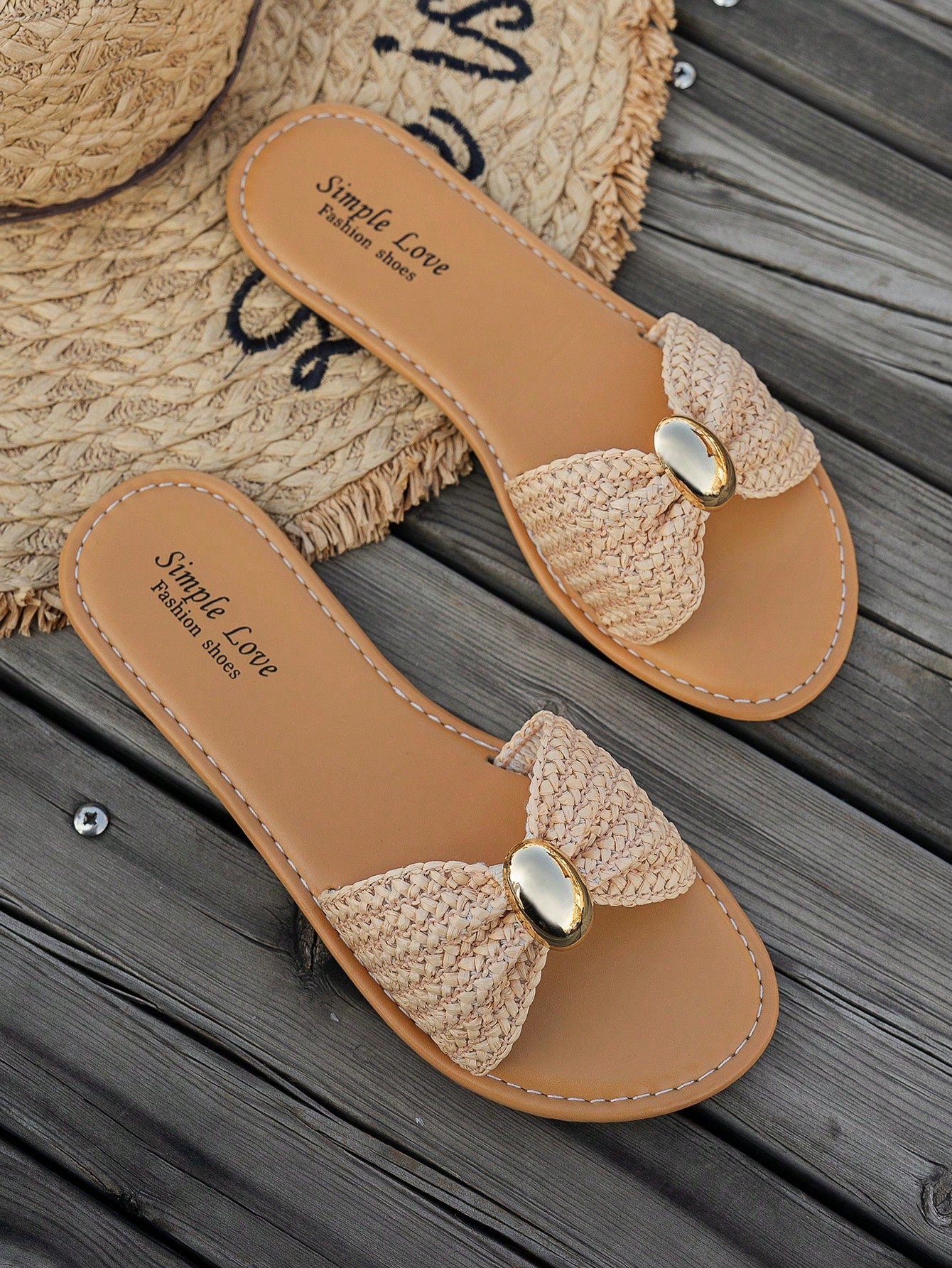 Women's brown straw woven flat slide sandals with bowknot metal decor, braided open-toe strap, and round toe.