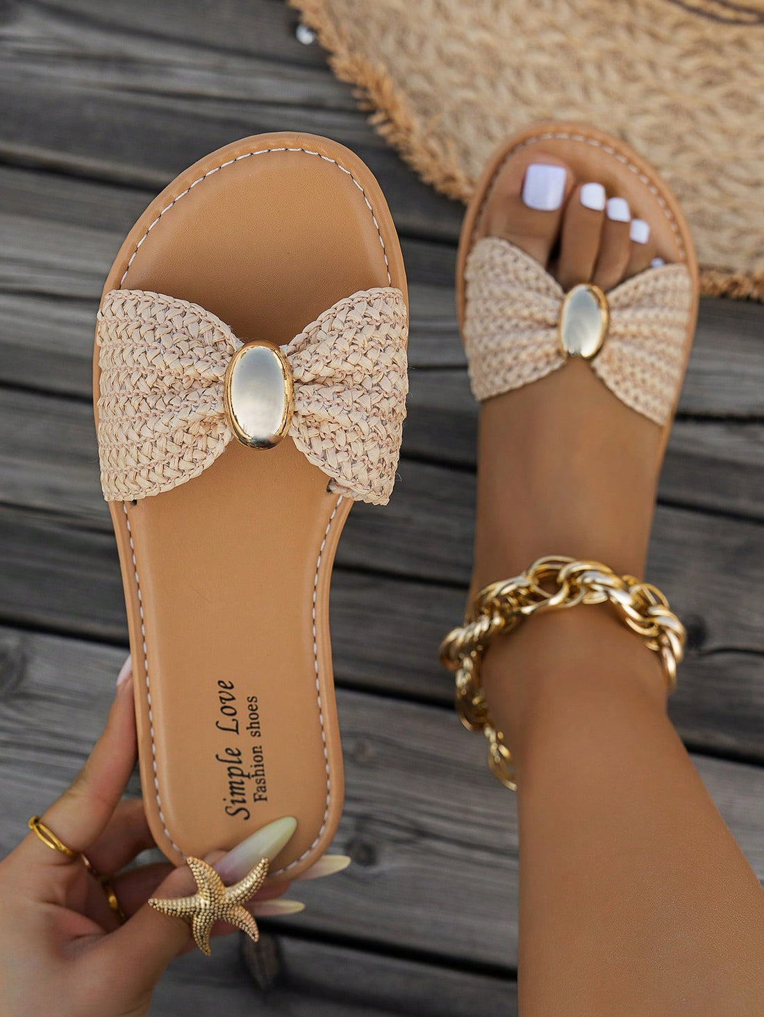 Women's brown straw woven flat slide sandals with bowknot metal decor, braided open-toe strap, and round toe.